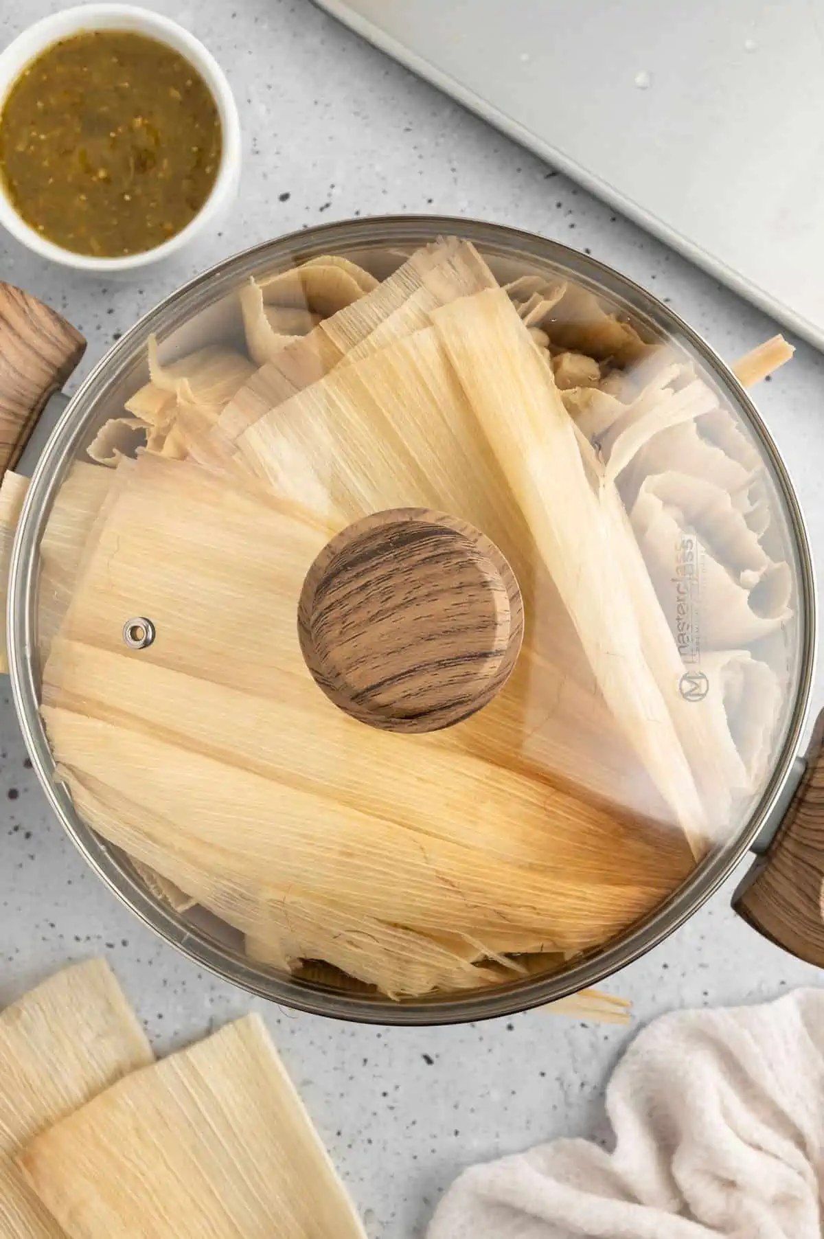 Vegan Tamales in a steamer with a lid on the top.