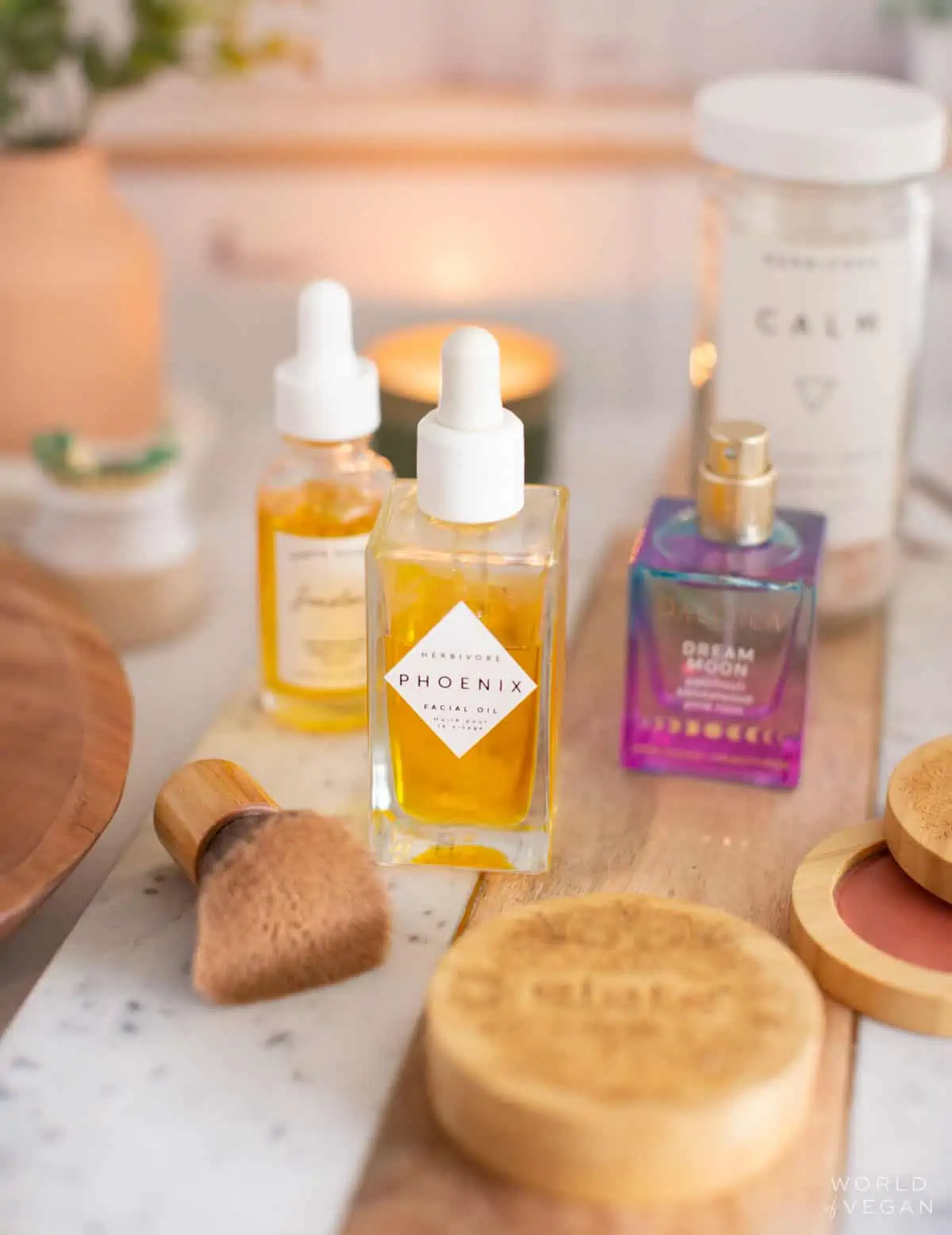 A bottle of Herbivore Botanicals face oil surrounded by other vegan makeup products.