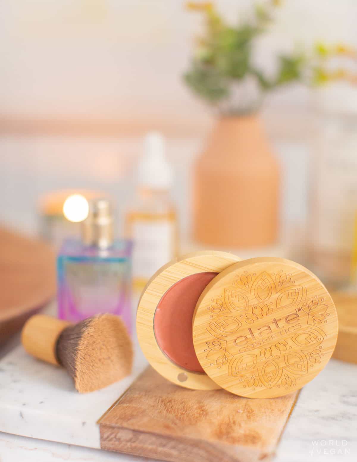 Elate Cosmetics blush surrounded by other vegan makeup products and brands.