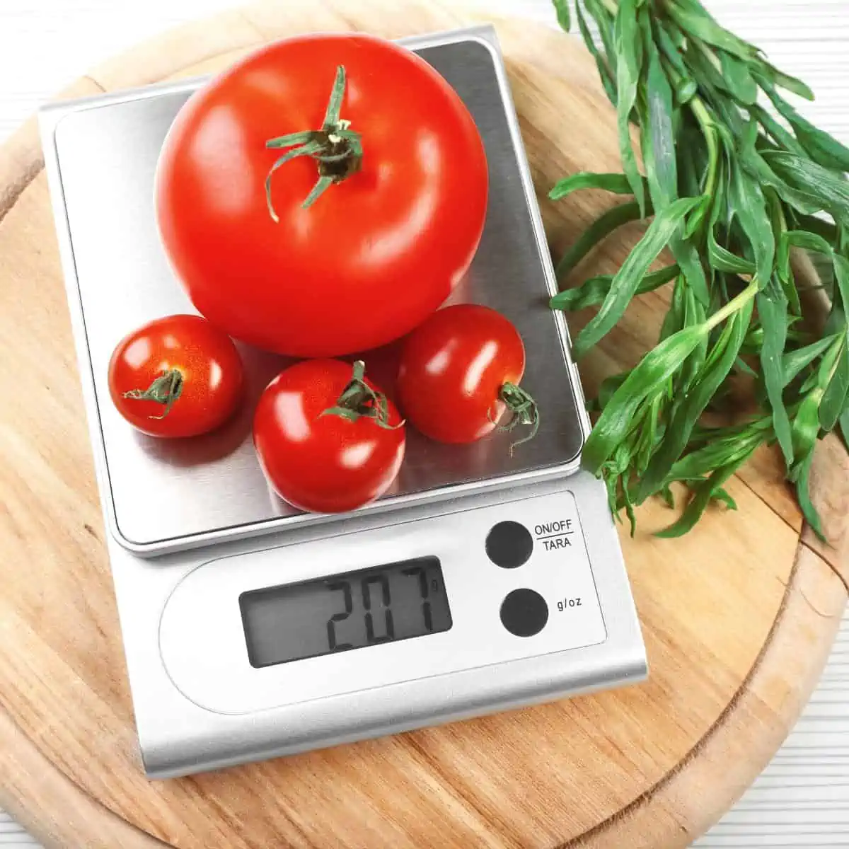 Tomatoes on a food scale measuring grams by weight. 