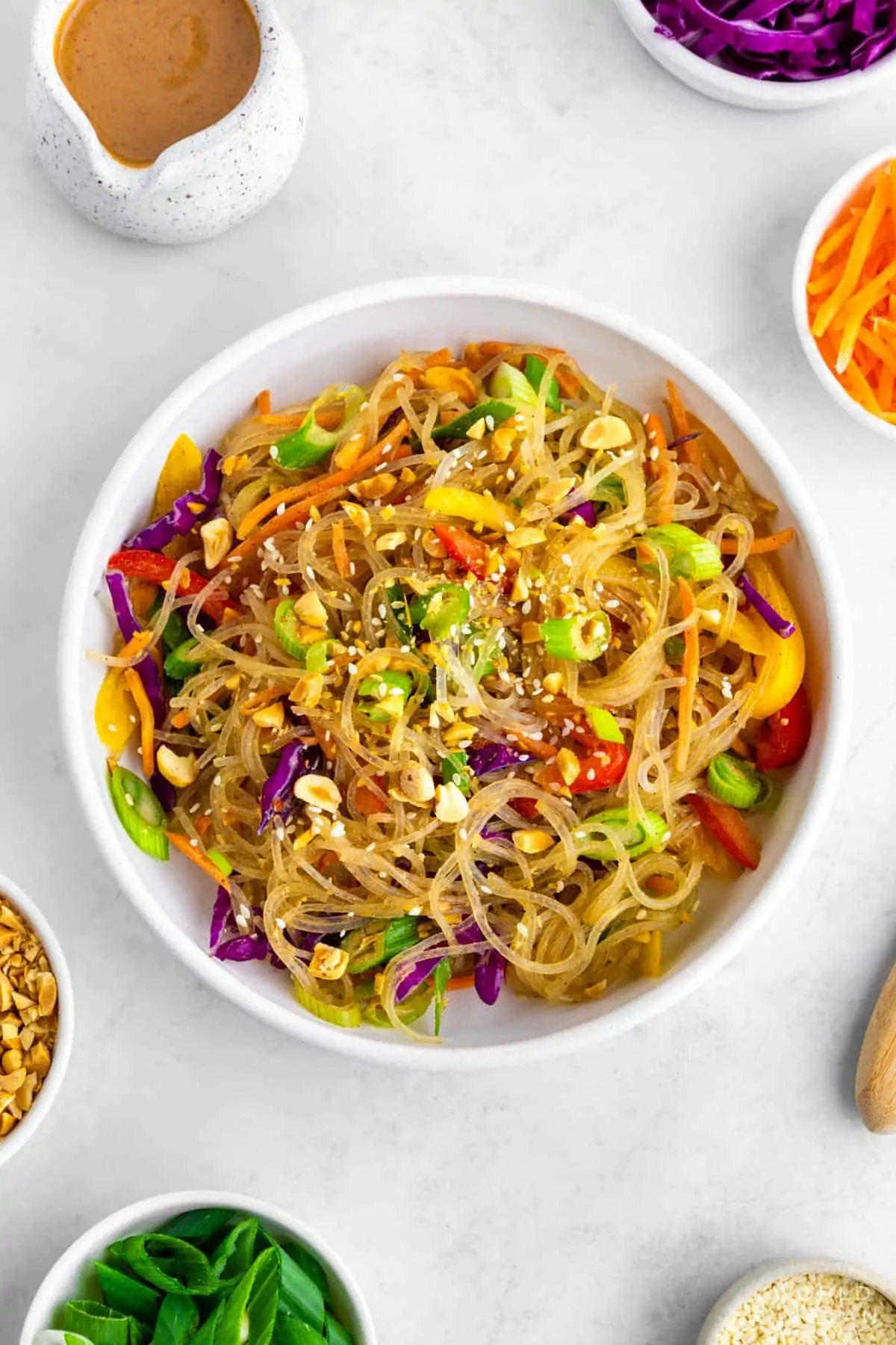 Flatlay of kelp noodles, glass noodle salad with veggies, and ingredients. 