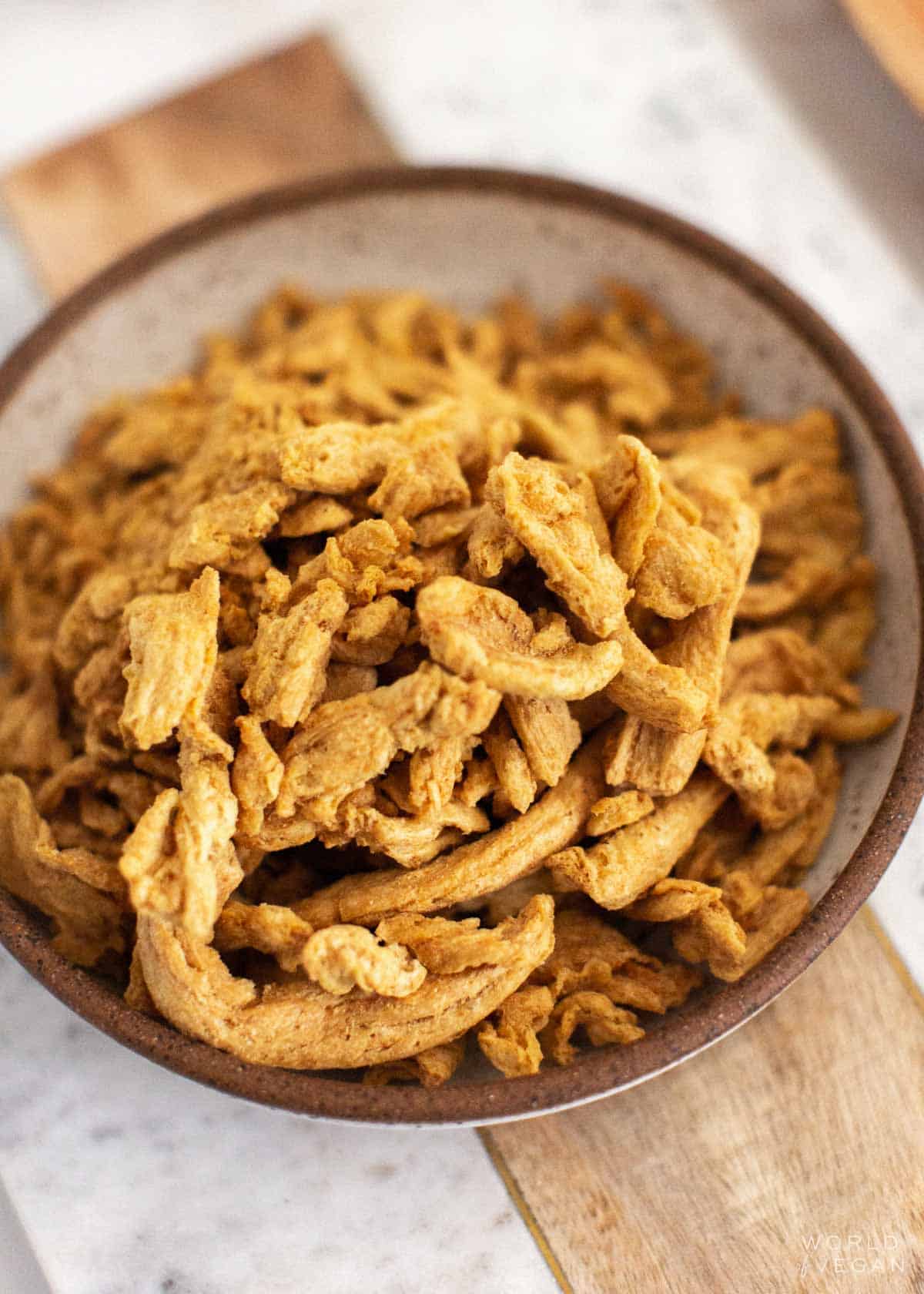 Plain dehydrated soy curls in a rustic dish. 