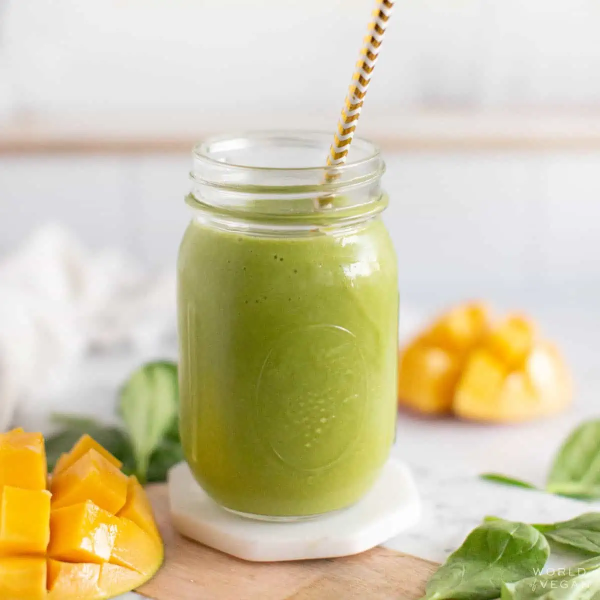 A mango spinach smoothie on a tabletop.