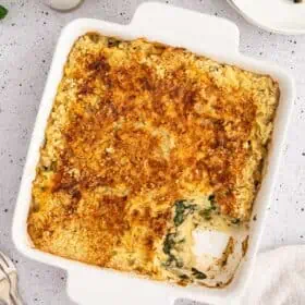 A top-down shot of a vegan casserole, with one piece cut out.