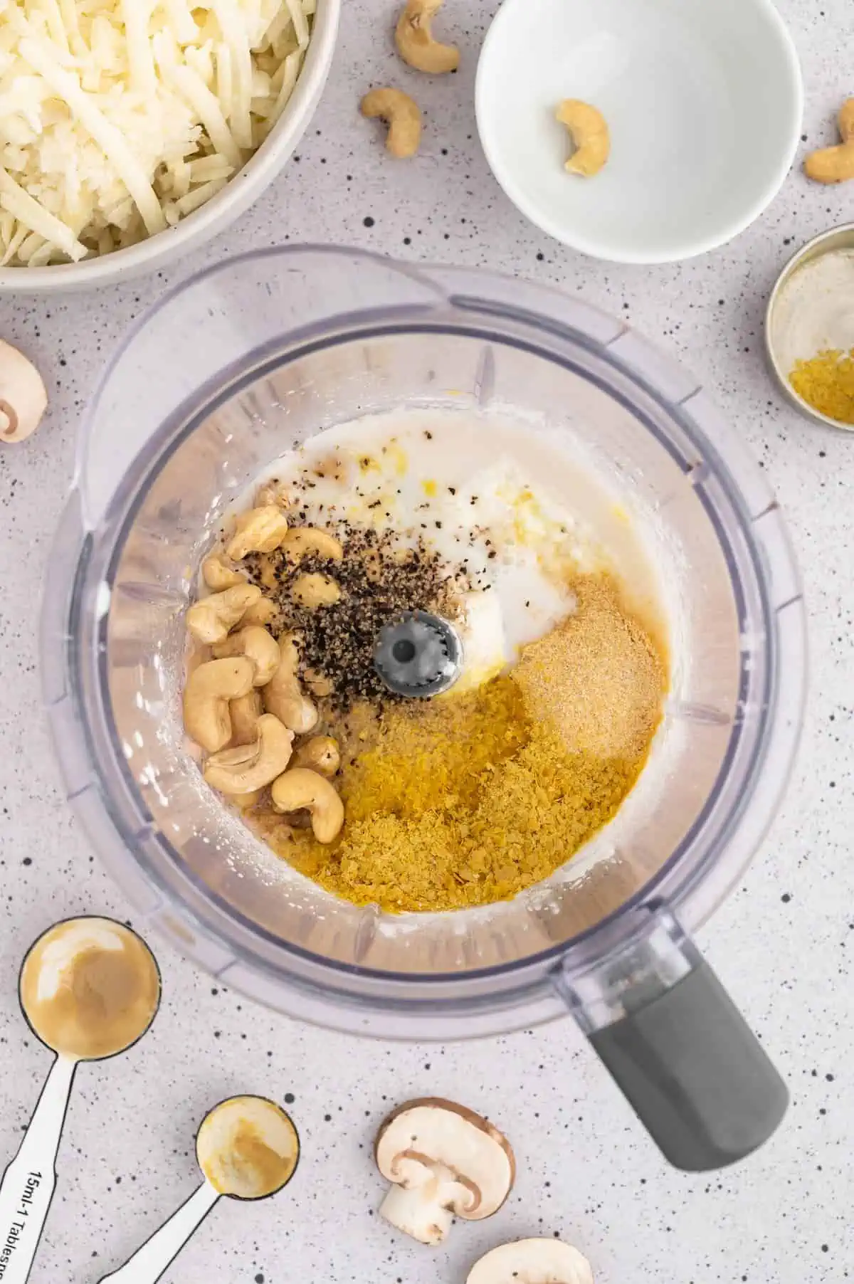 Ingredients for a vegan cheese sauce in a blender.