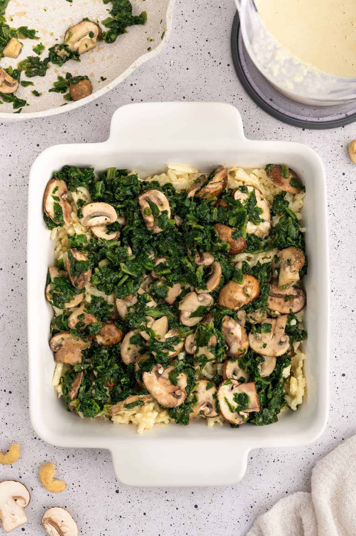 A spinach and mushroom mixture in a casserole dish.