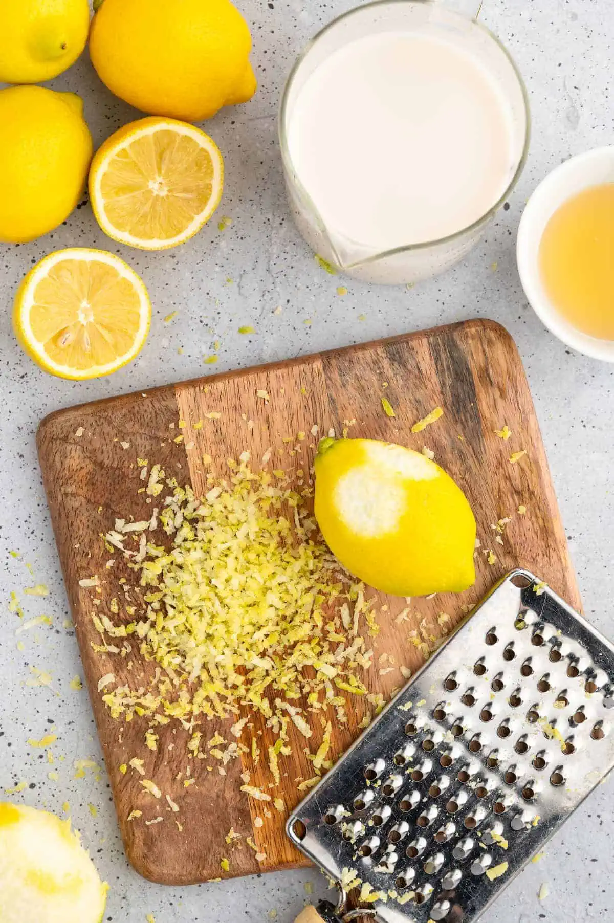 Zesting lemon on a cutting board.
