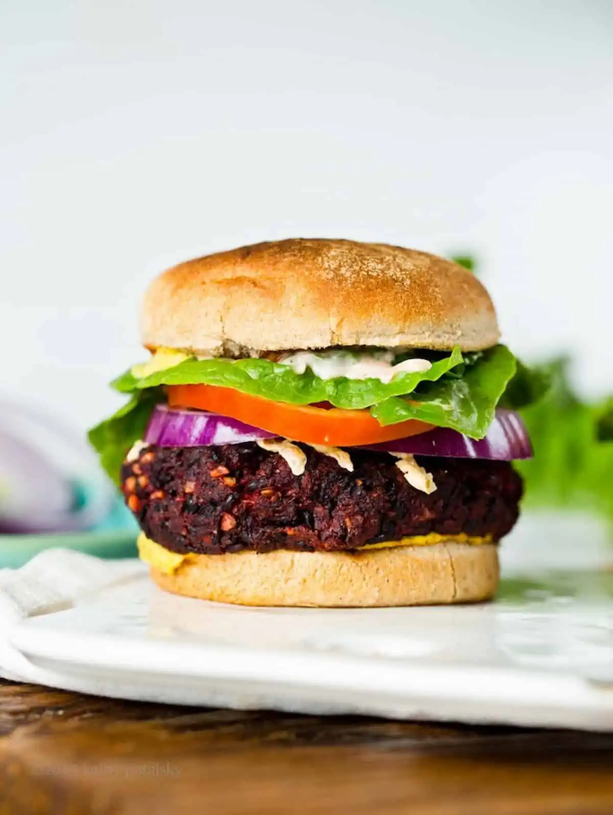 Beet burger with toppings and bun.