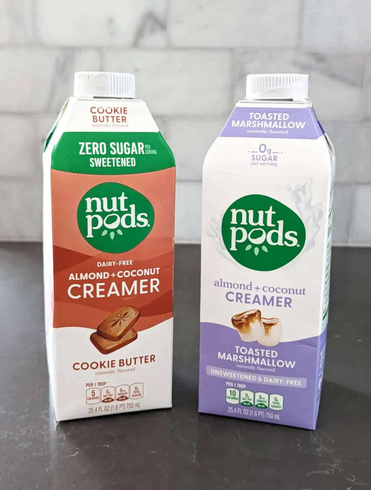 Two cartons of Nutpods vegan coffee creamers on a countertop.