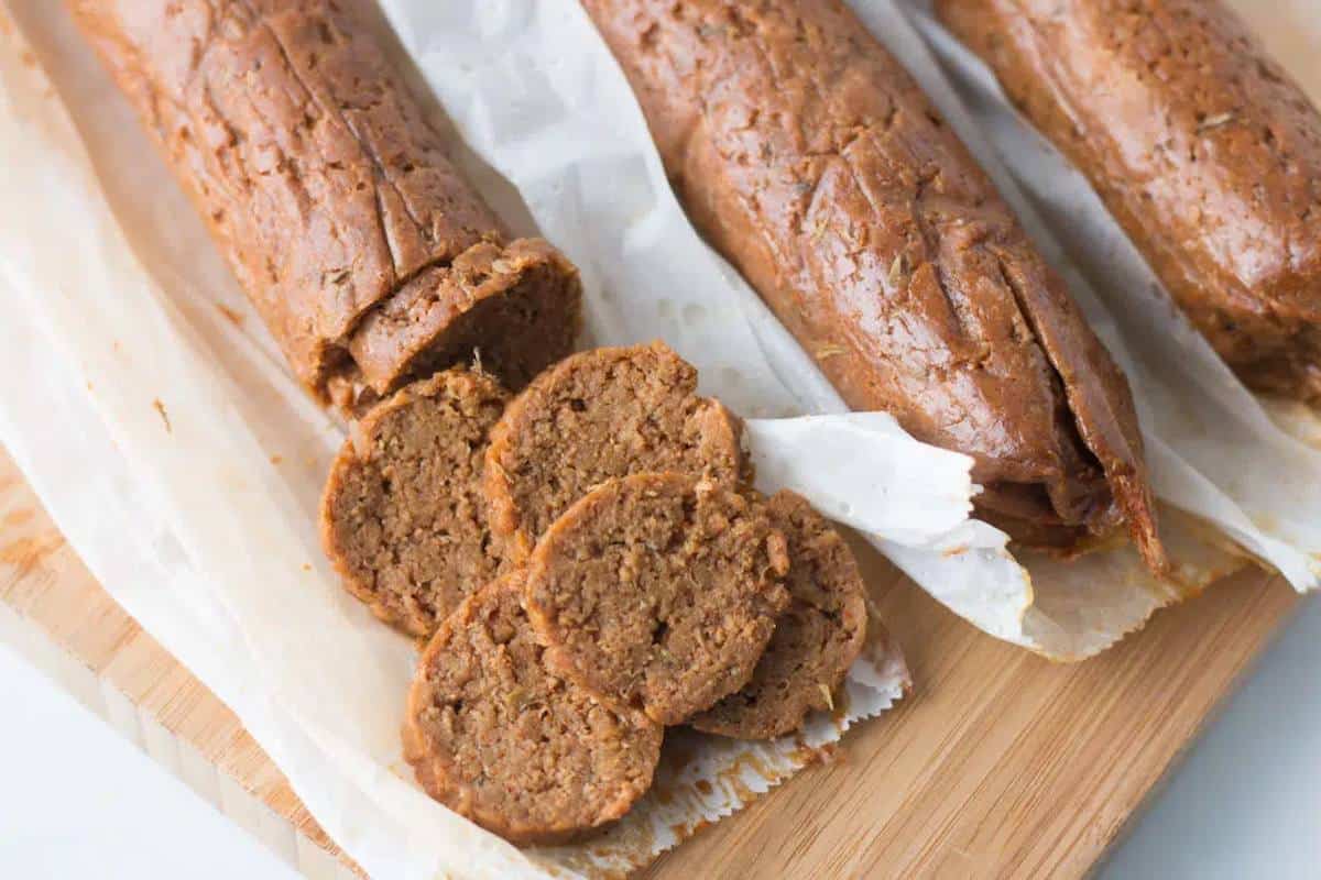 Sliced vegan Andouille sausage on parchment paper.