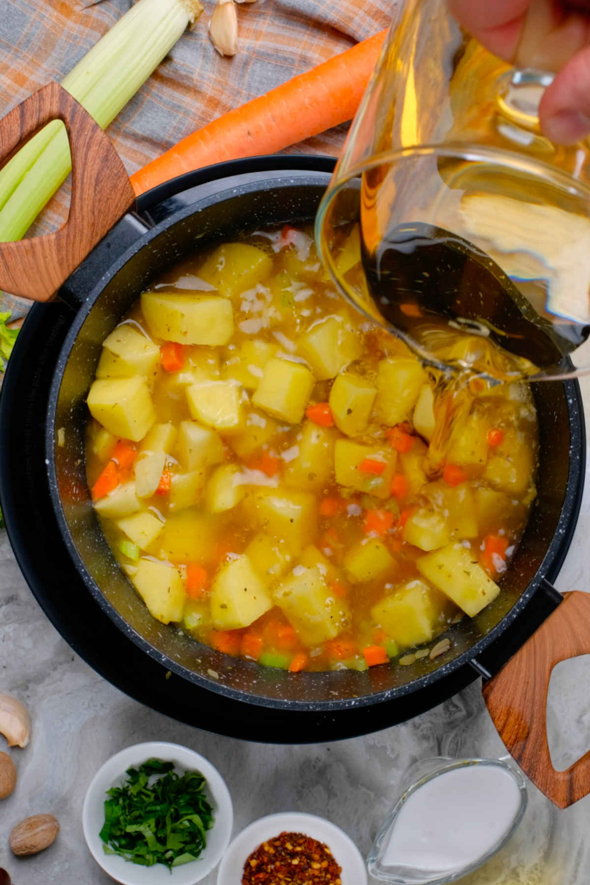 Vegetables and vegetable broth added to the large soup pan.