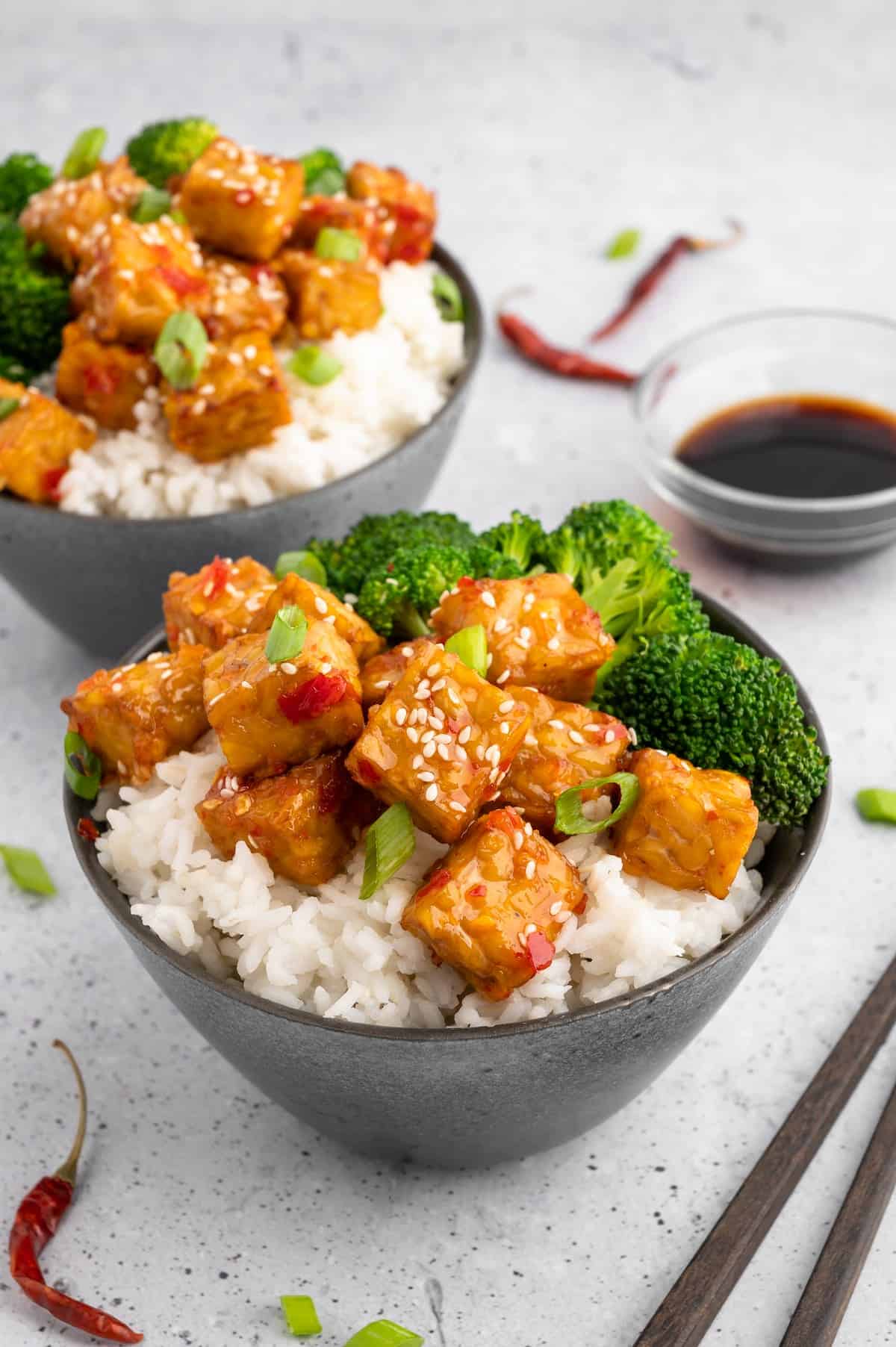 Air fryer tempeh in bowls with broccoli.