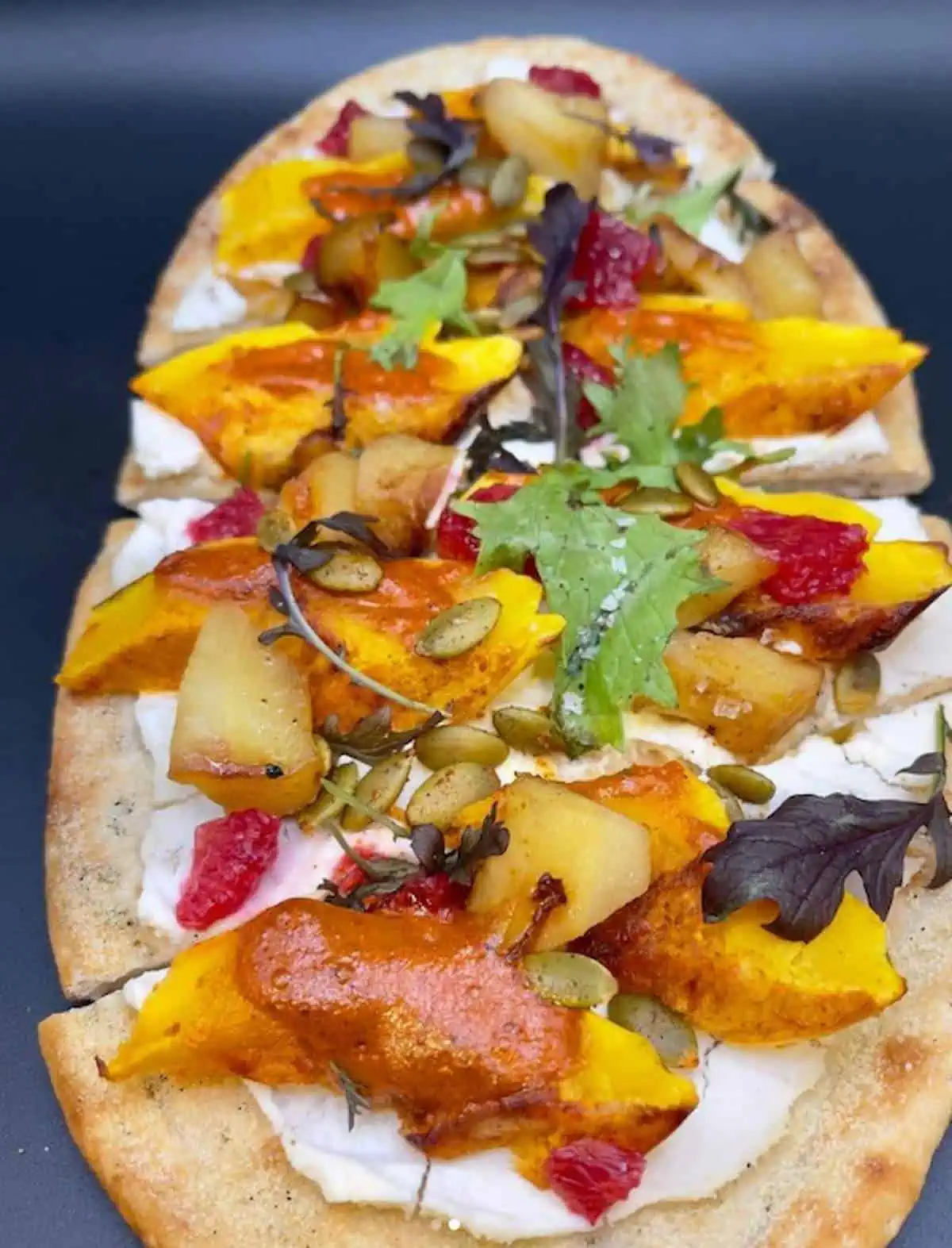 Flatbread topped with roasted delicata squash and house-made harissa.