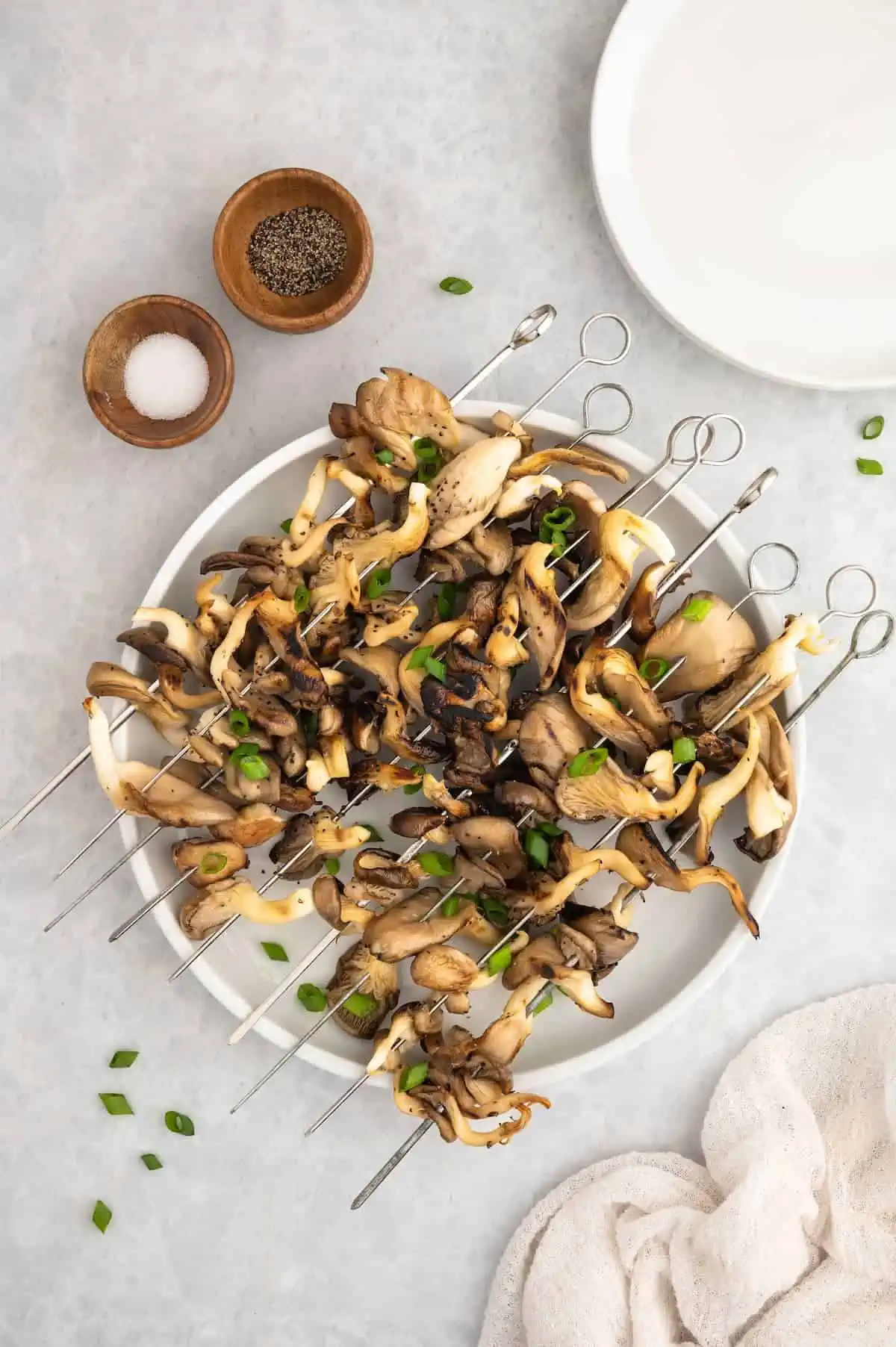 A plate of grilled mushroom skewers.