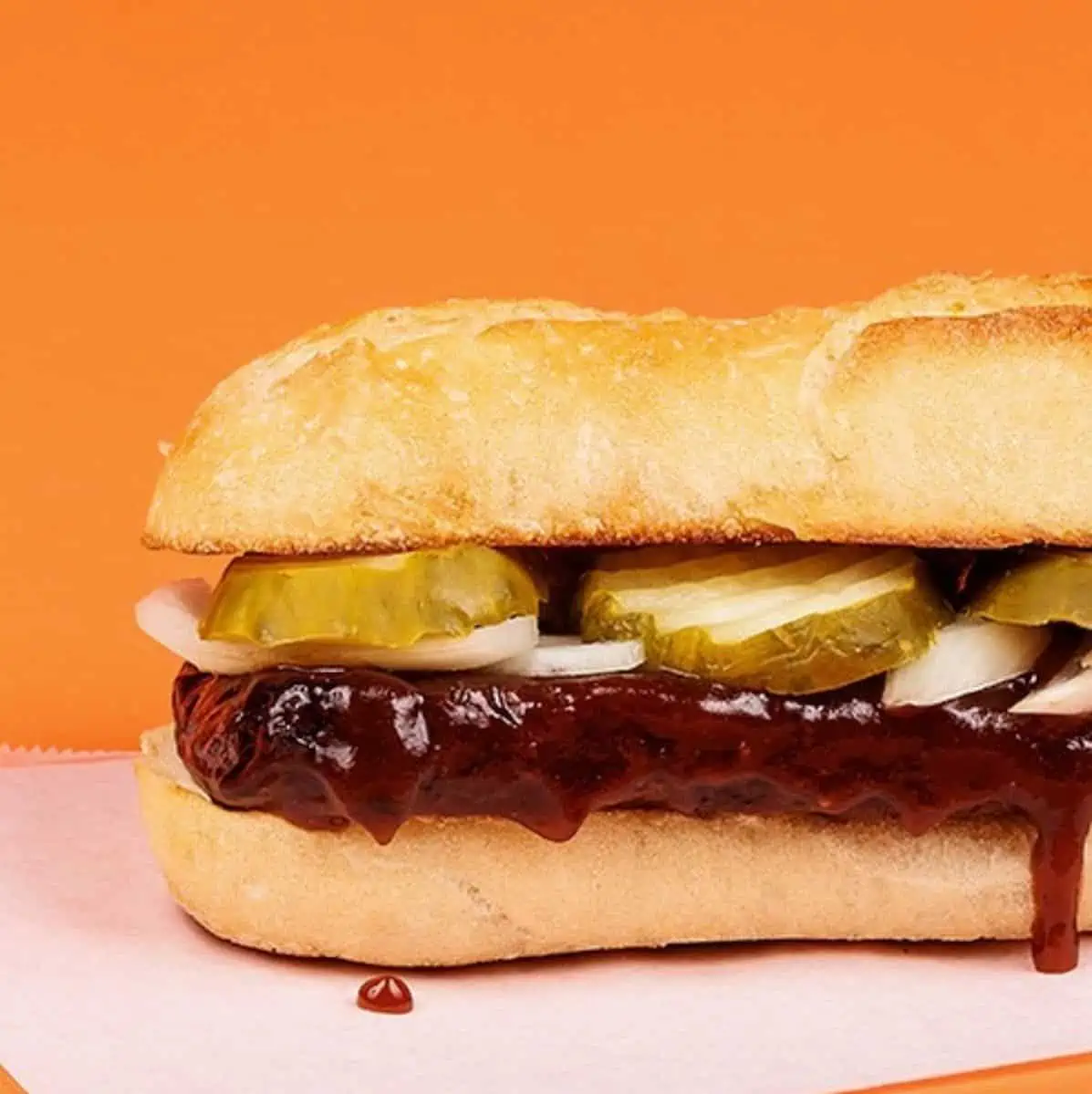 A VeggRib sandwich dripping with sauce.