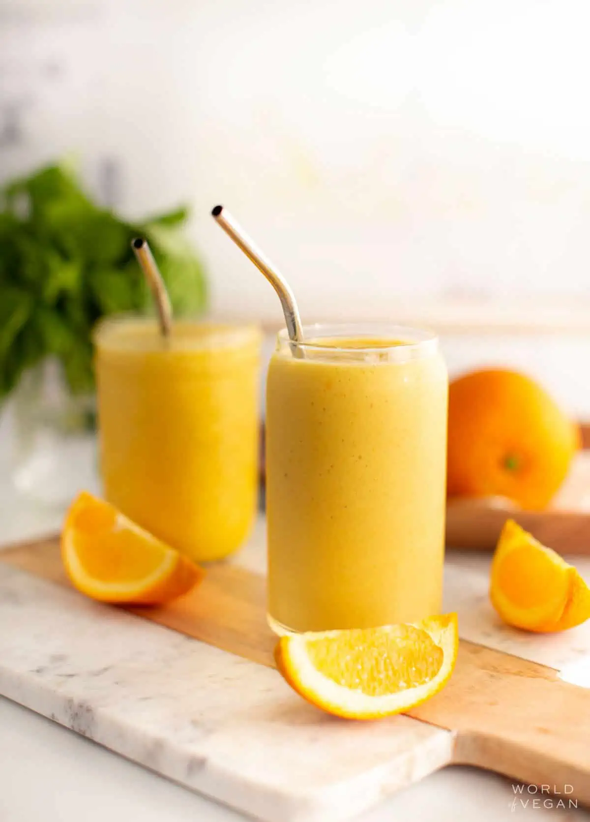Two glasses of orange juice smoothies.