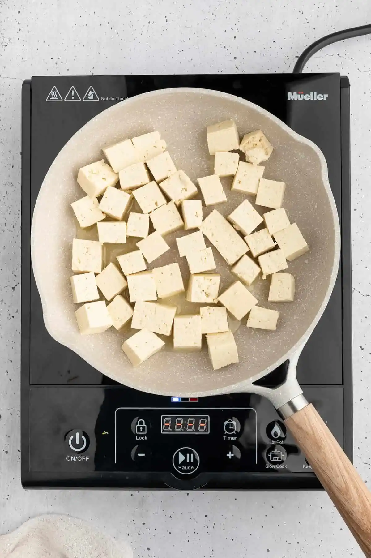 Tofu cubes in a pan.