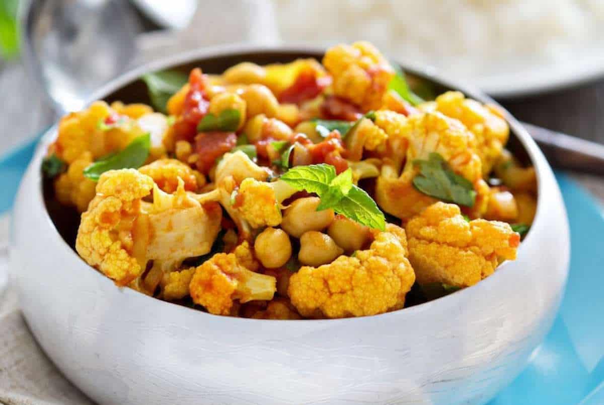 Vegan Indian curry in a bowl with cauliflower and chickpeas.