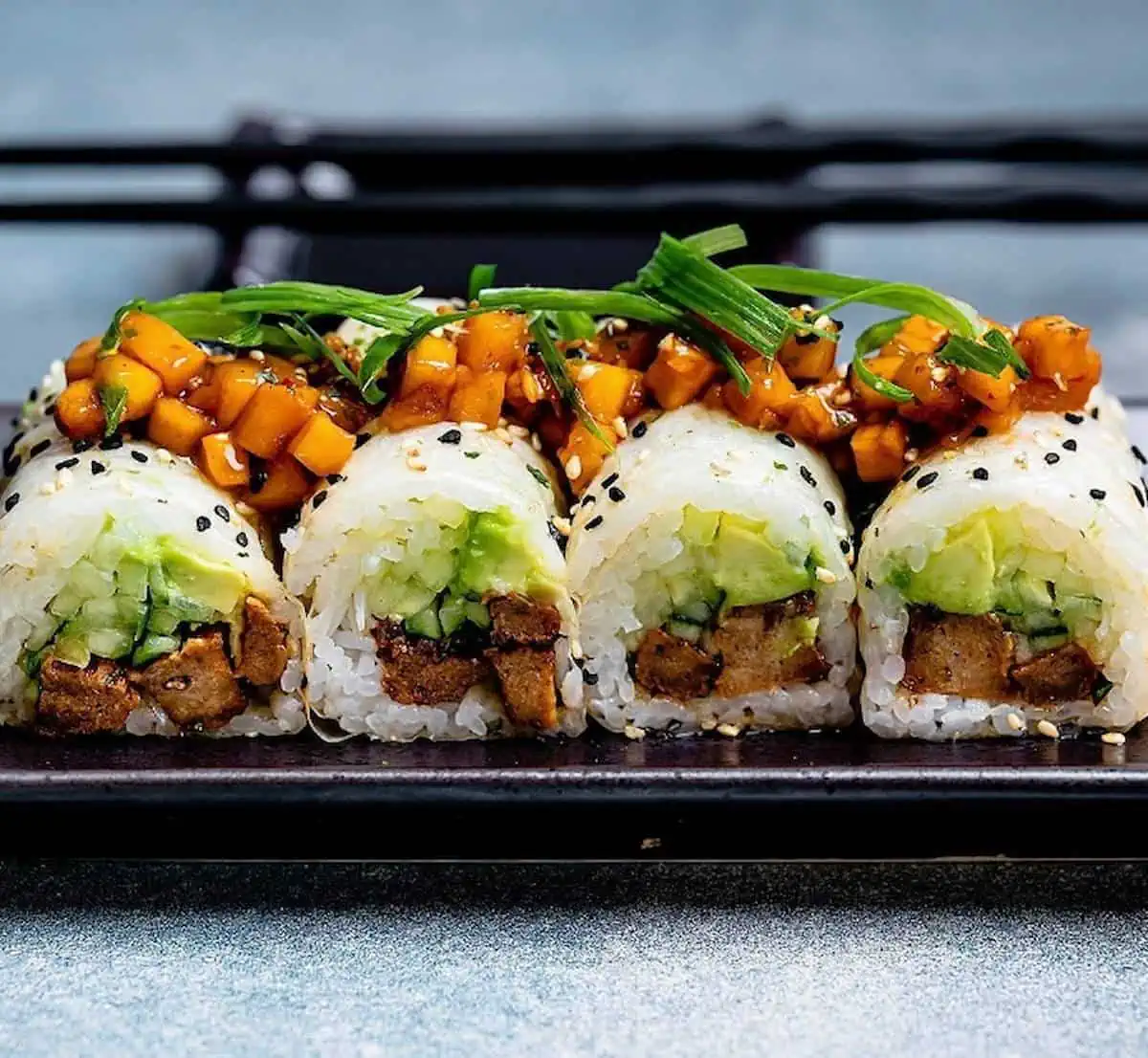 Teriyaki sushi rolls on a platter.