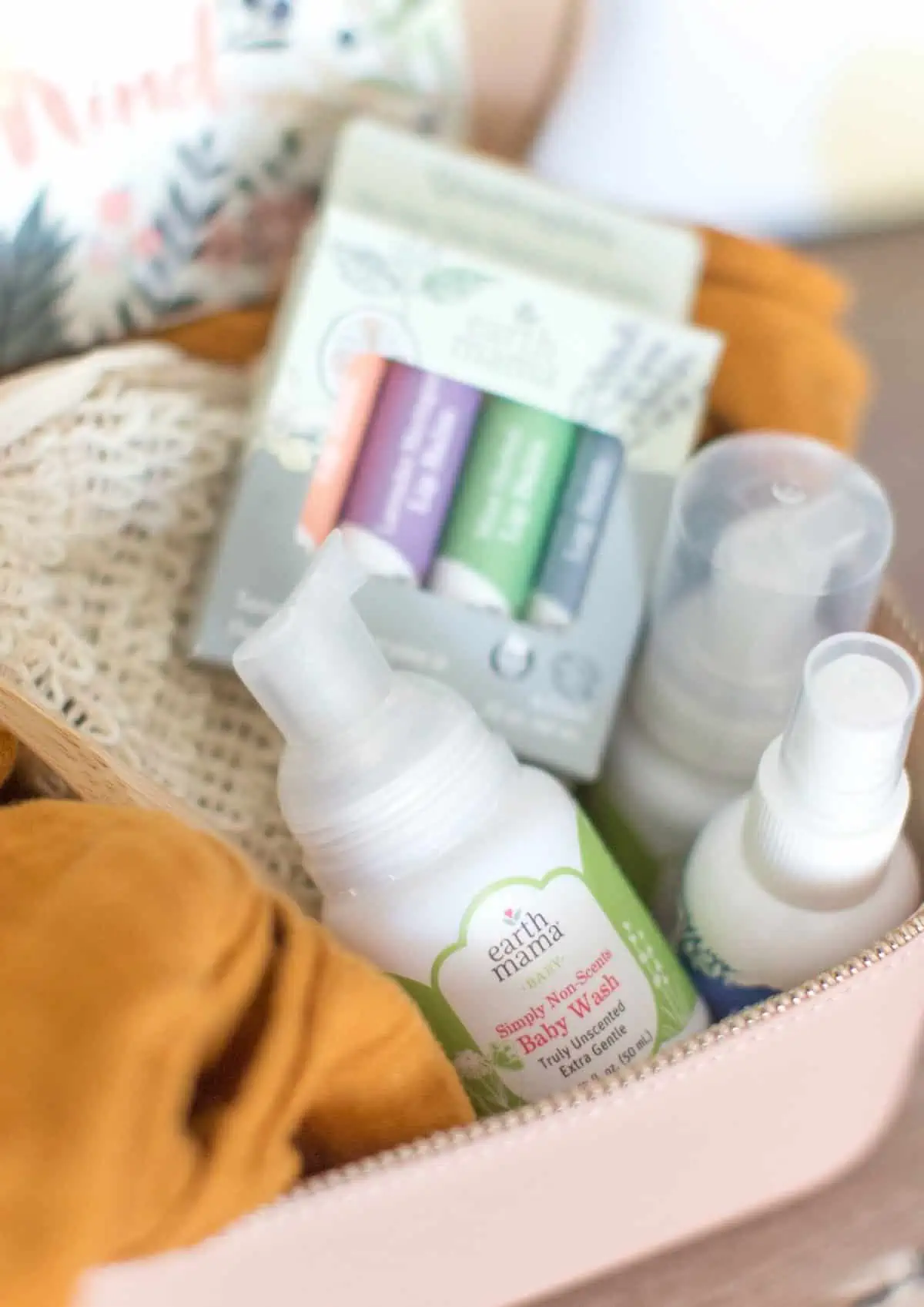 Toiletries bag with lip balm and Earth Mama baby body wash soap. 