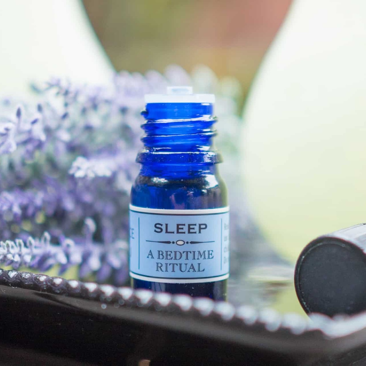 A blue bottle of essential oils by the brand Essense of Vali called sleep.