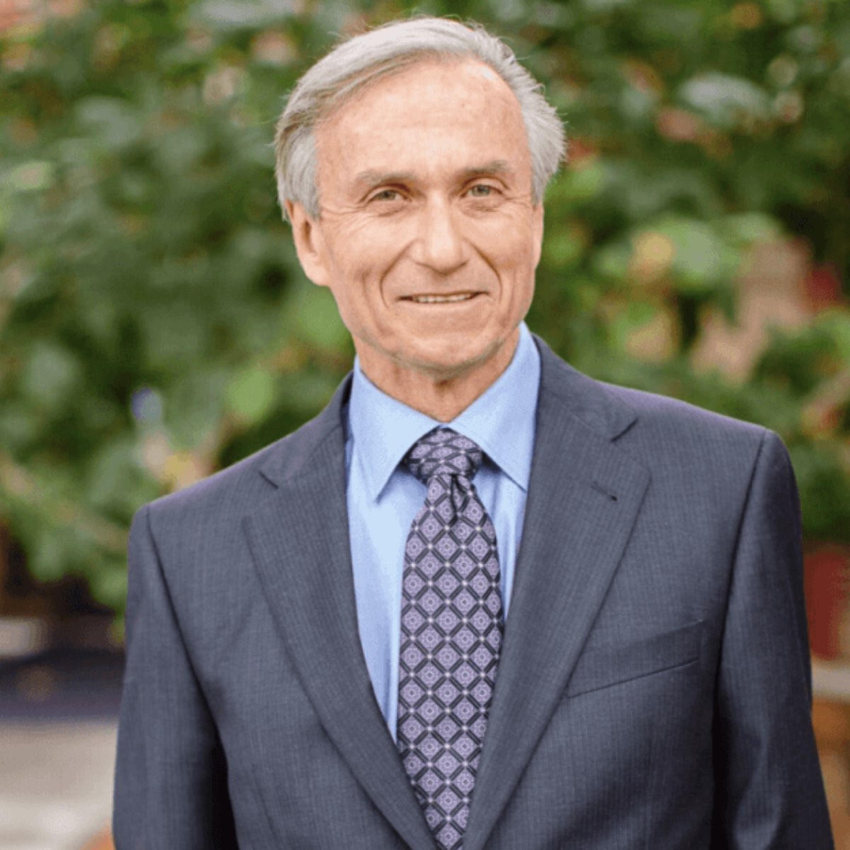 Photo of plant-based doctor Dr. John McDougall in a suit. 