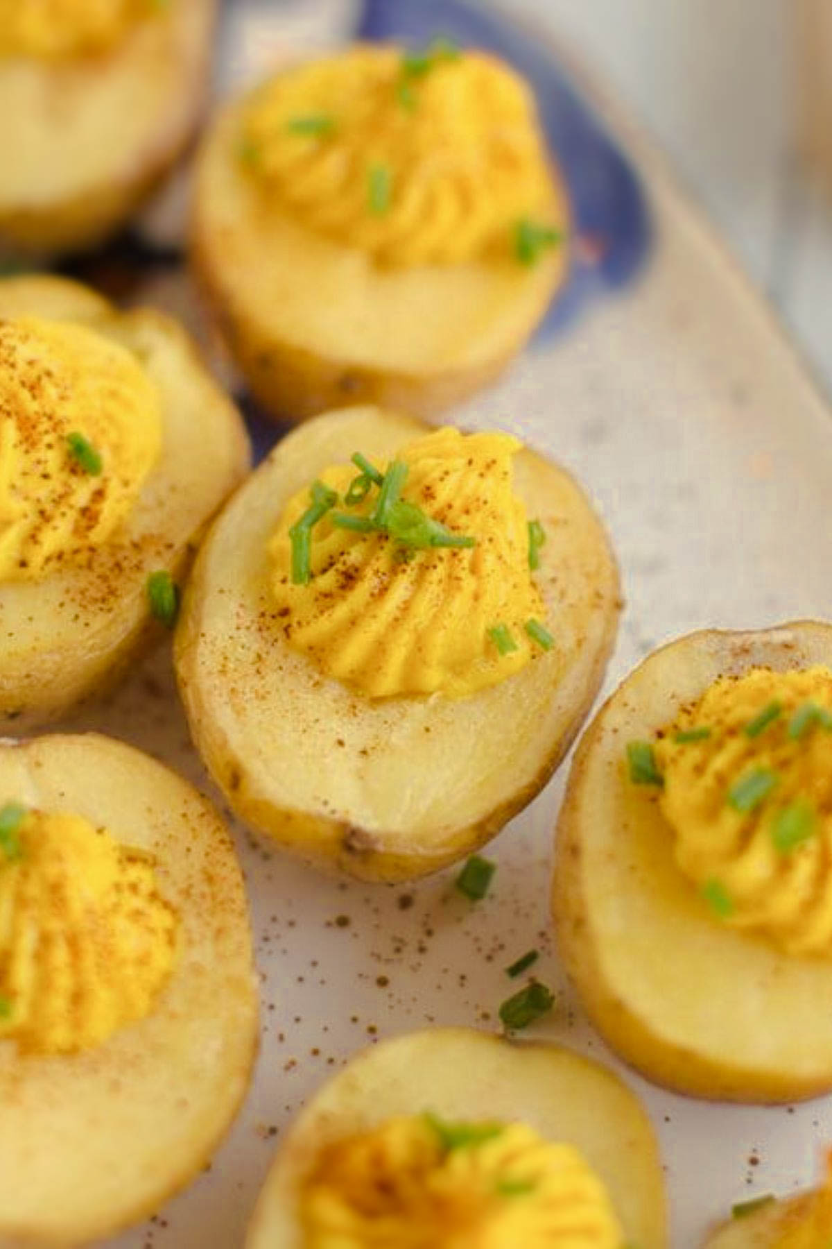 A serving of egg-free deviled potatoes, garnished with paprika and fresh herbs, perfect for appetizers or a holiday spread.