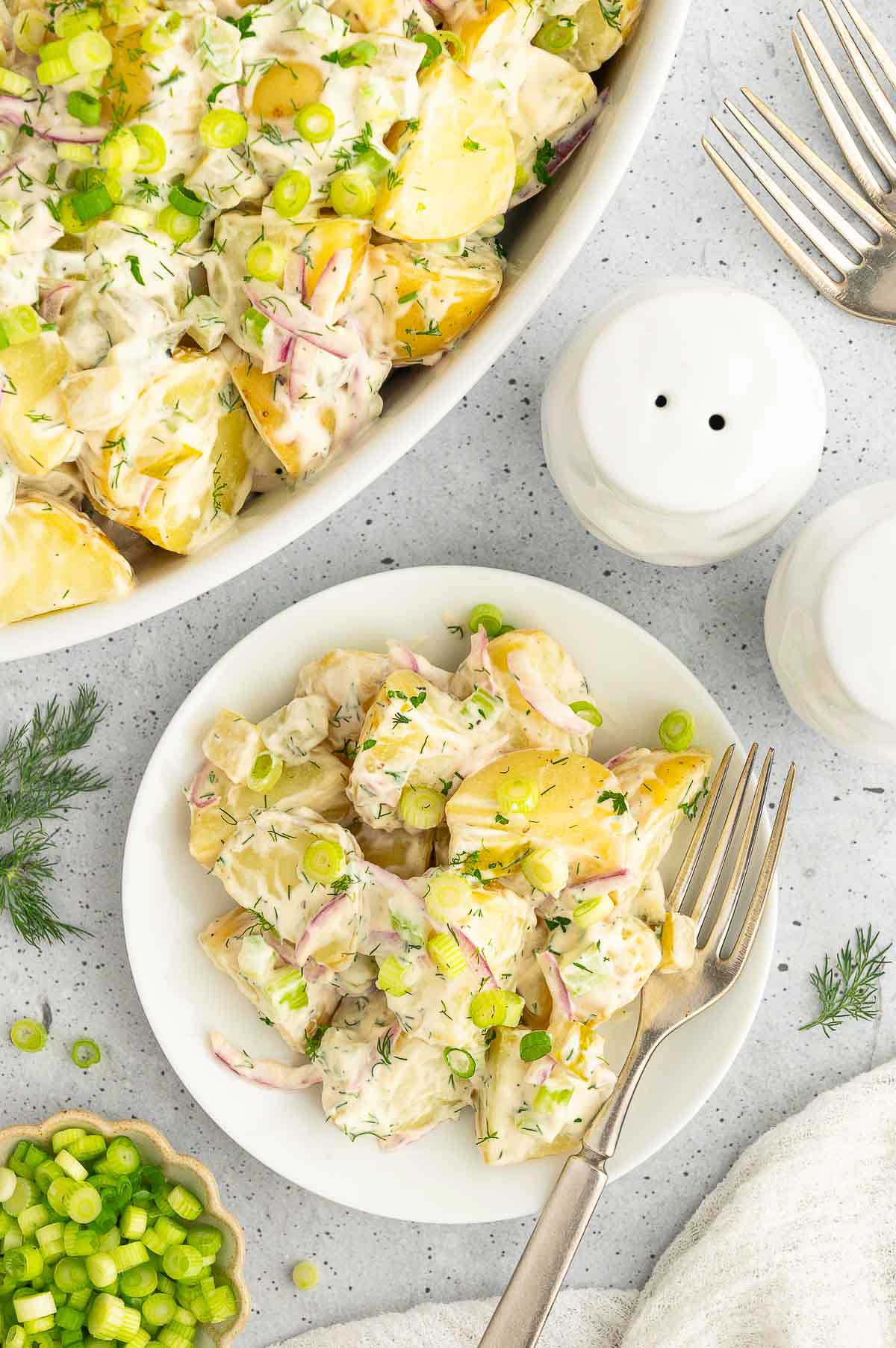 Vegan potato salad on a plate with a fork.