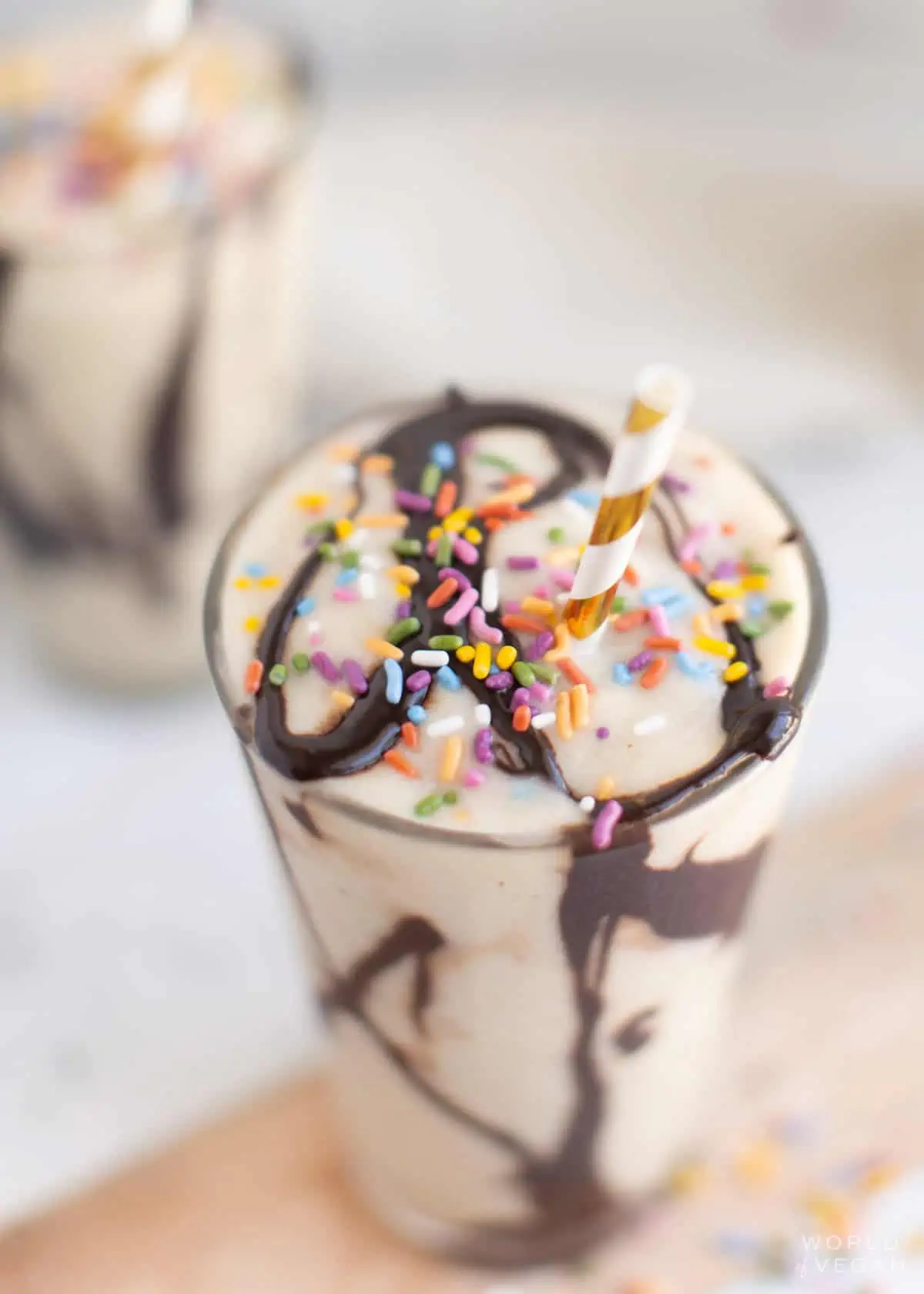 Sprinkles on top of a banana milkshake.