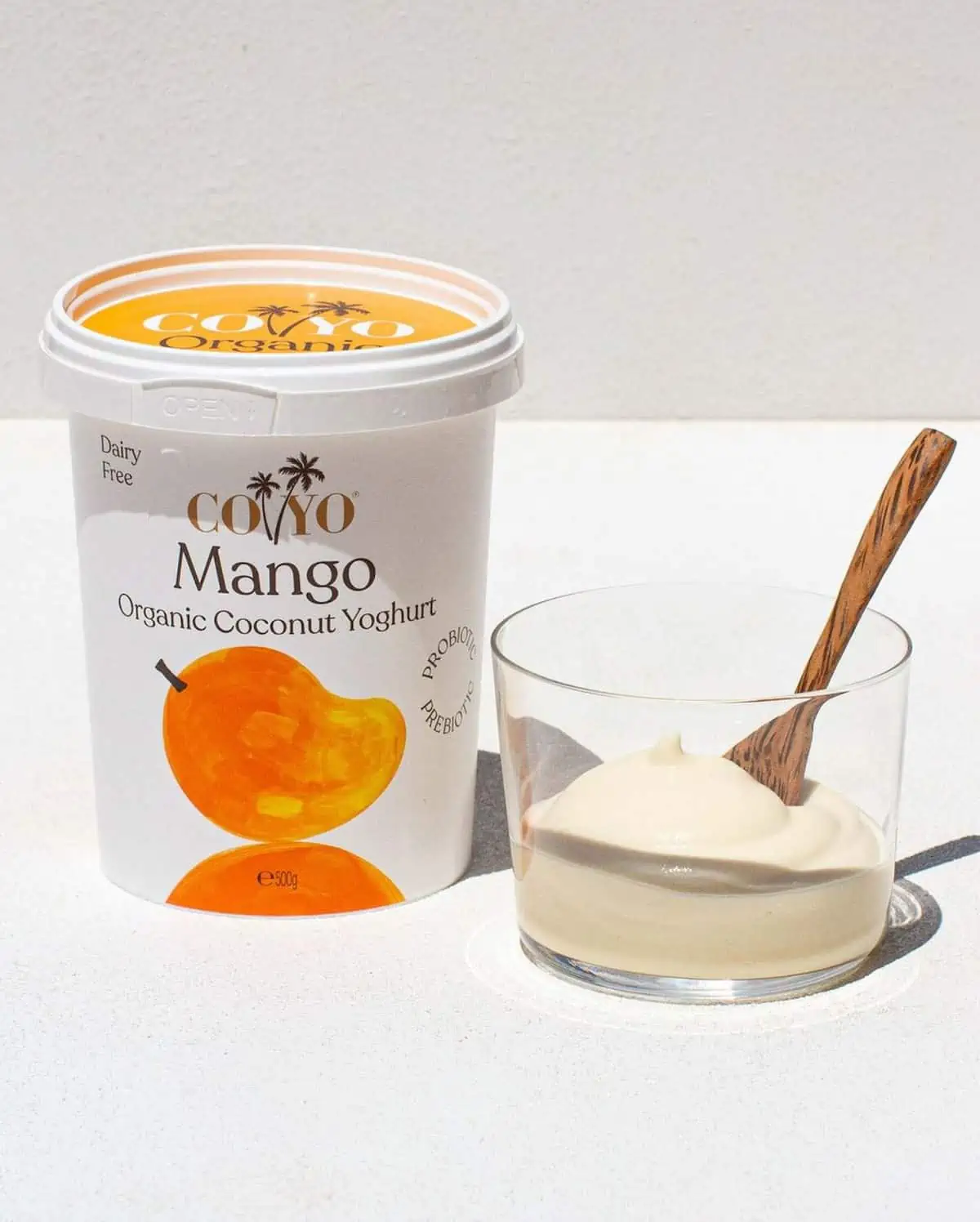 A container of Coyo brand vegan mango coconut yogurt.