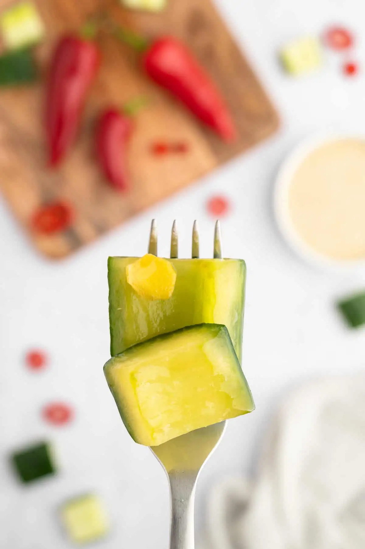 A couple pieces of Japanese pickled cucumber on a fork.