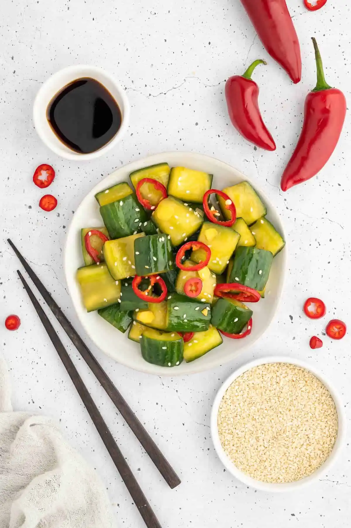 Japanese pickled cucumbers with chopsticks and sesame seeds.