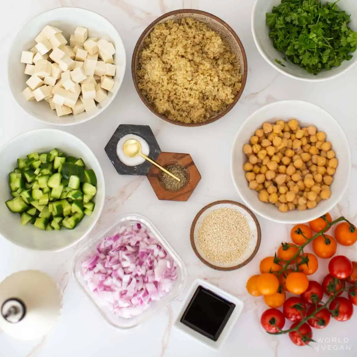 Ingredients for these vegan quinoa salads measured out and placed in individual bowls.