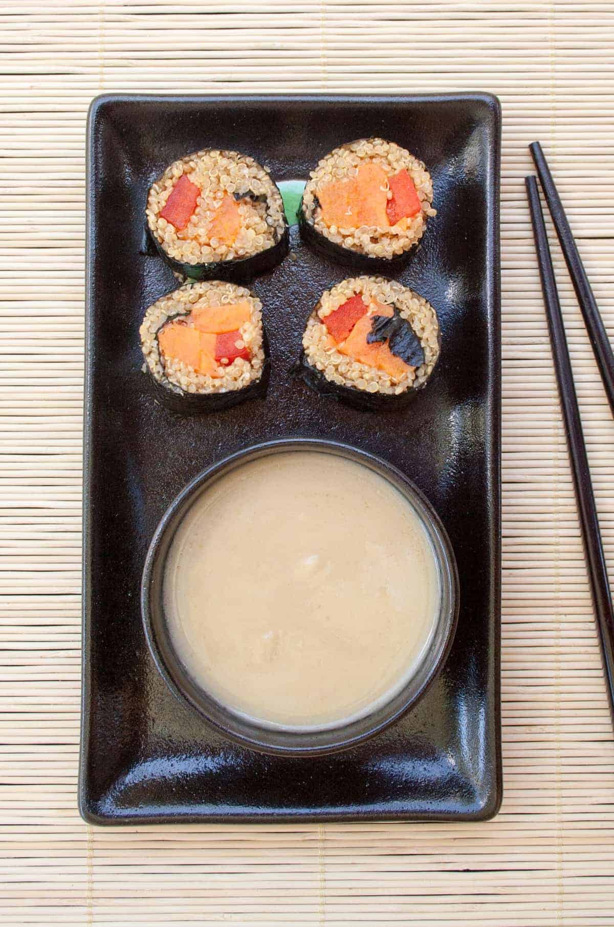 A plate of sweet potato maki rolls with quinoa.