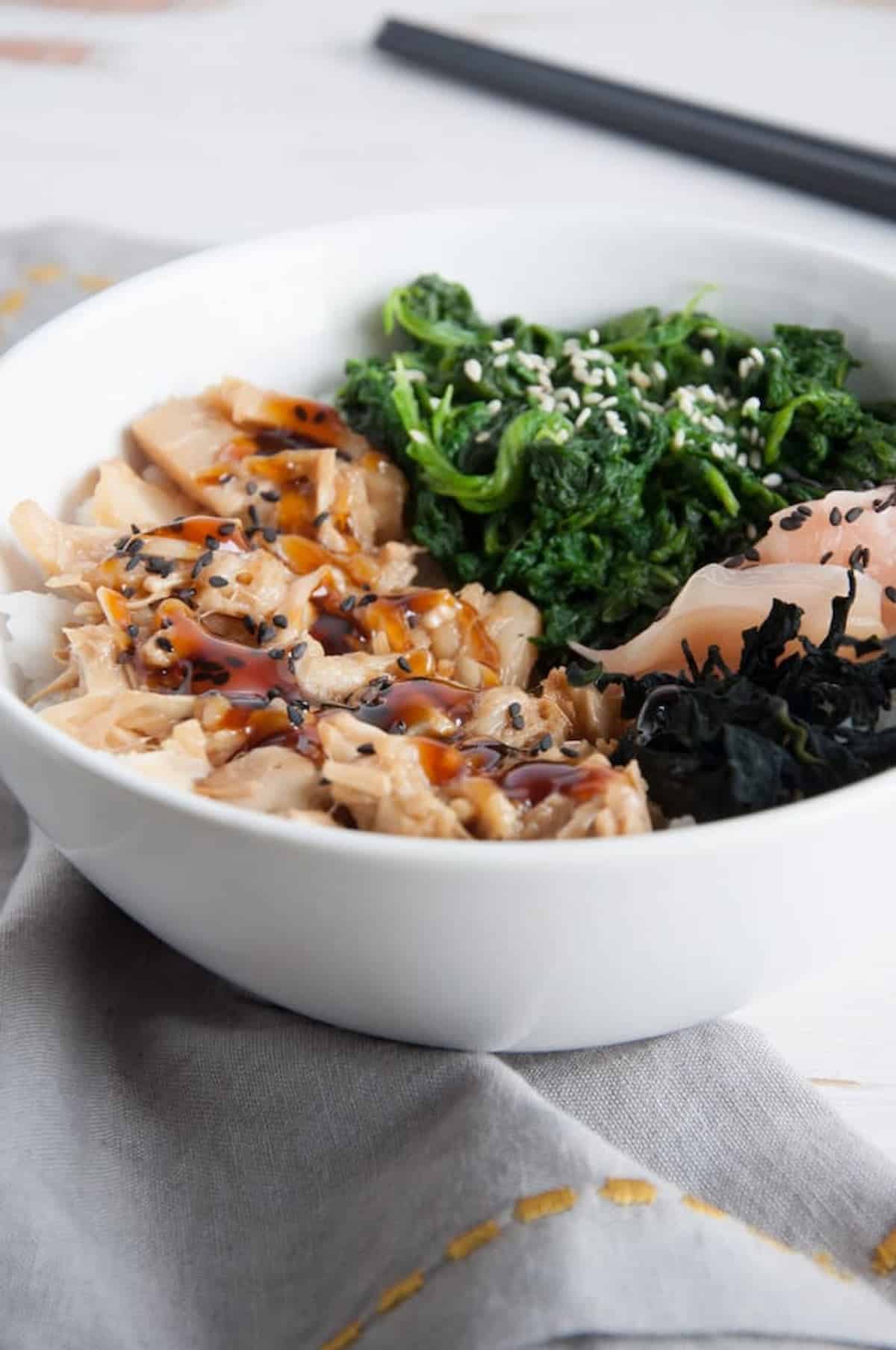 A bowl with teriyaki jackfruit, rice, and vegetables.