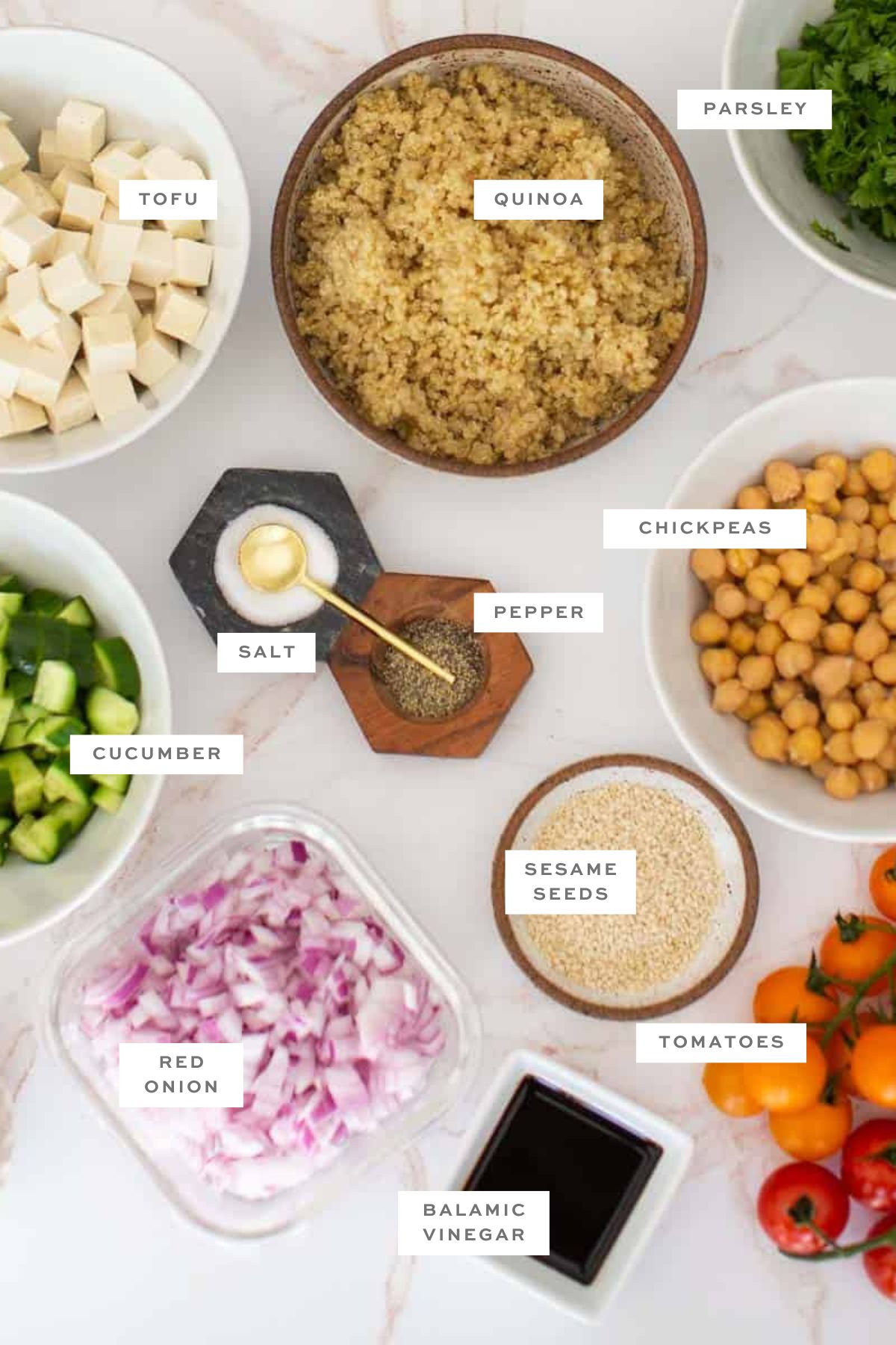 Ingredients for vegan quinoa salad in a jar with labels.