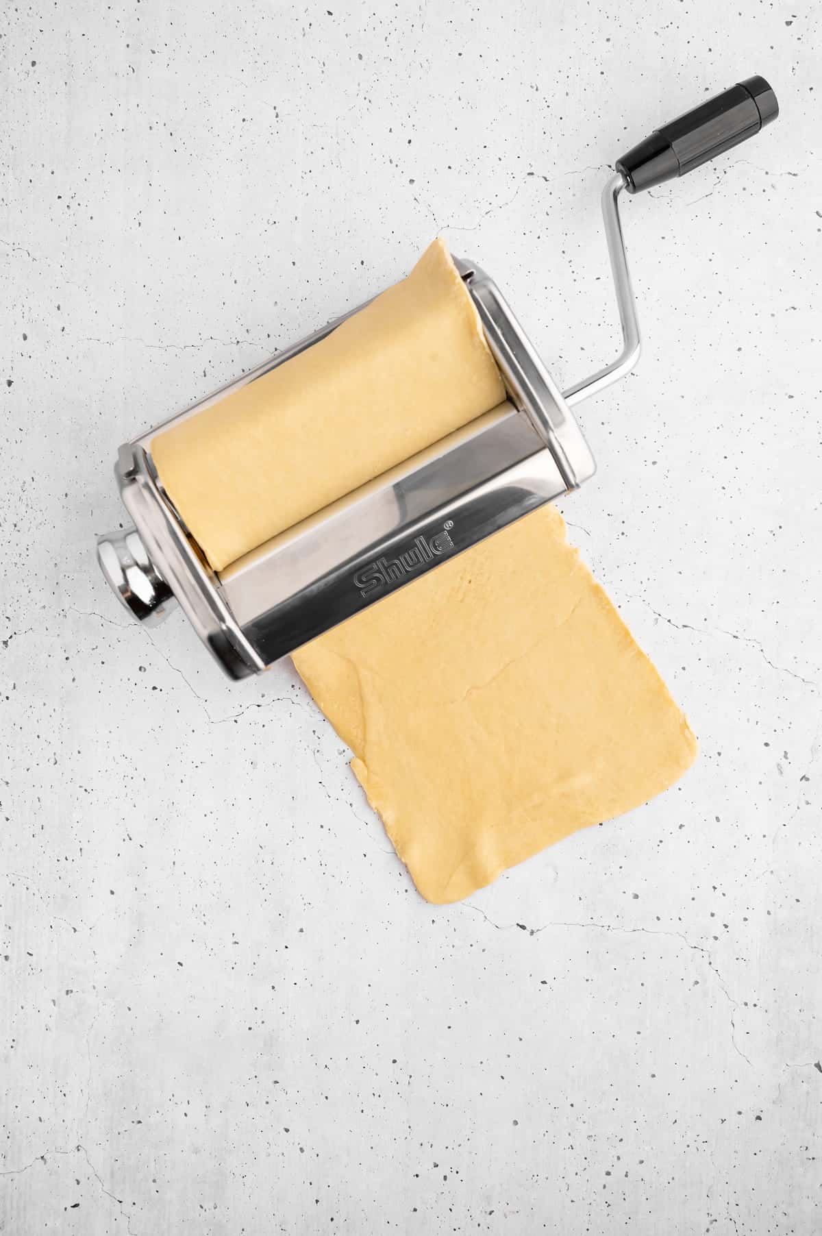 Dough rolled through a pasta-making machine.