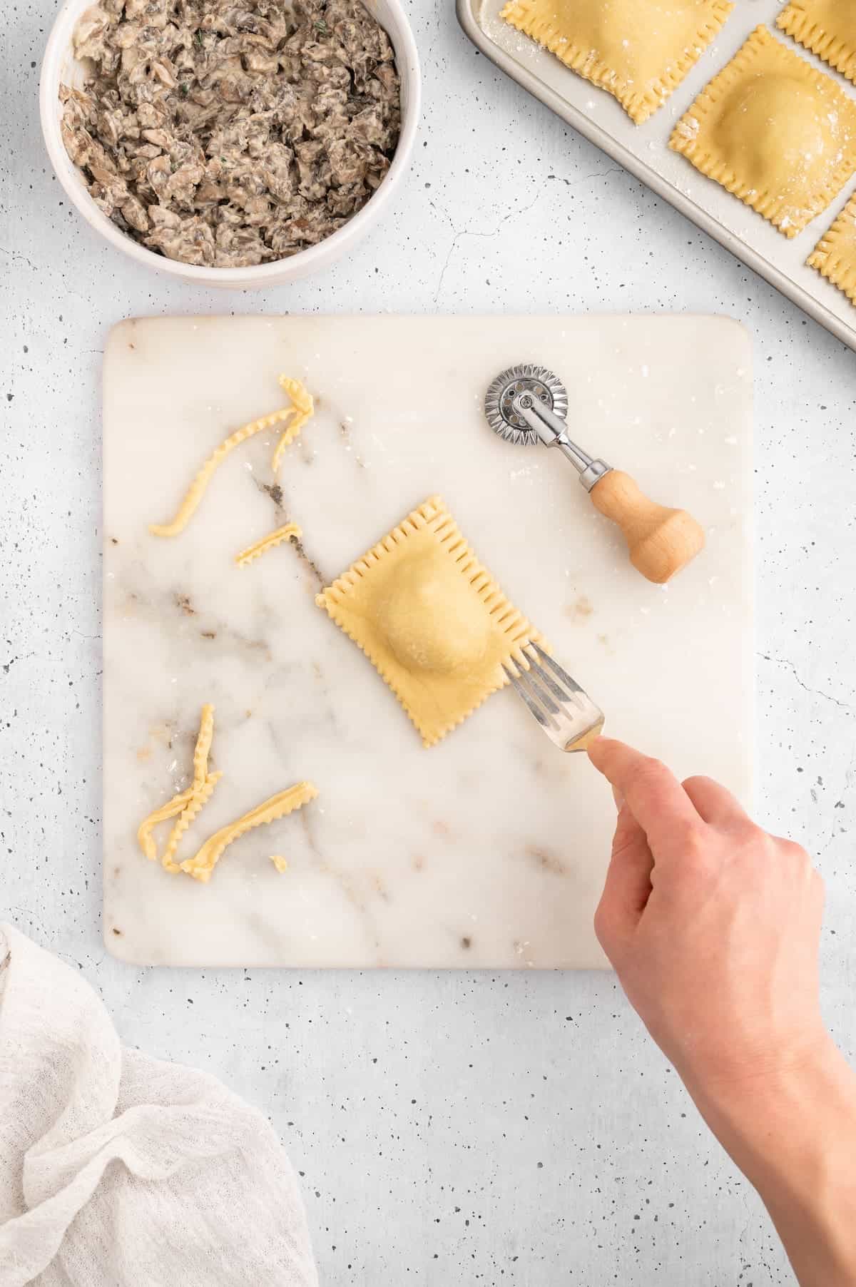 Vegan ravioli edges sealed with a fork.