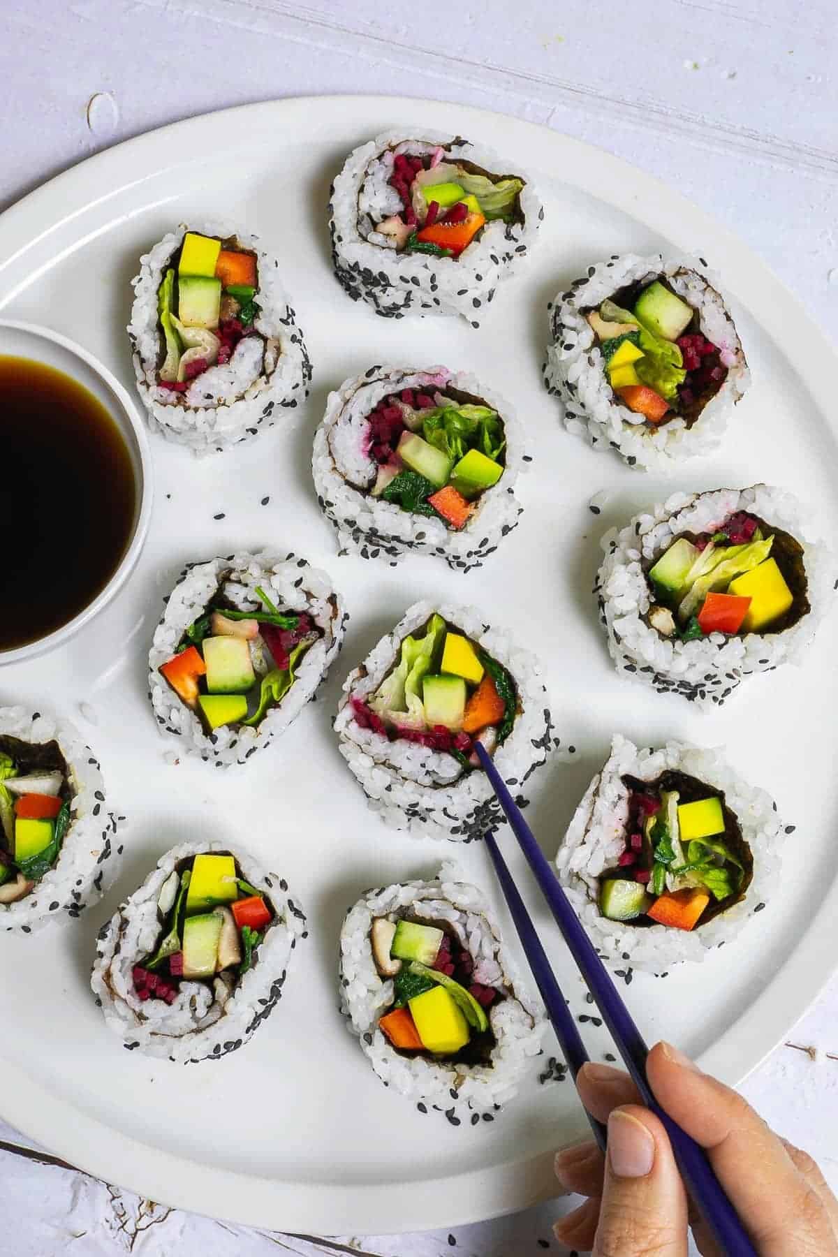 A plate of maki sushi rolls filled with vegetables.