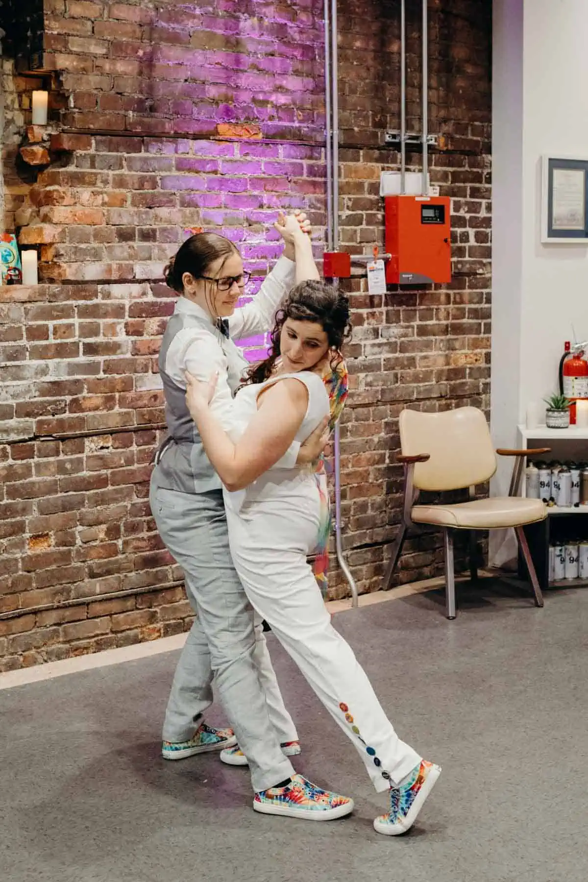 First dance at lesbian wedding with the beautiful vegan couple with rainbow outfit accents. 