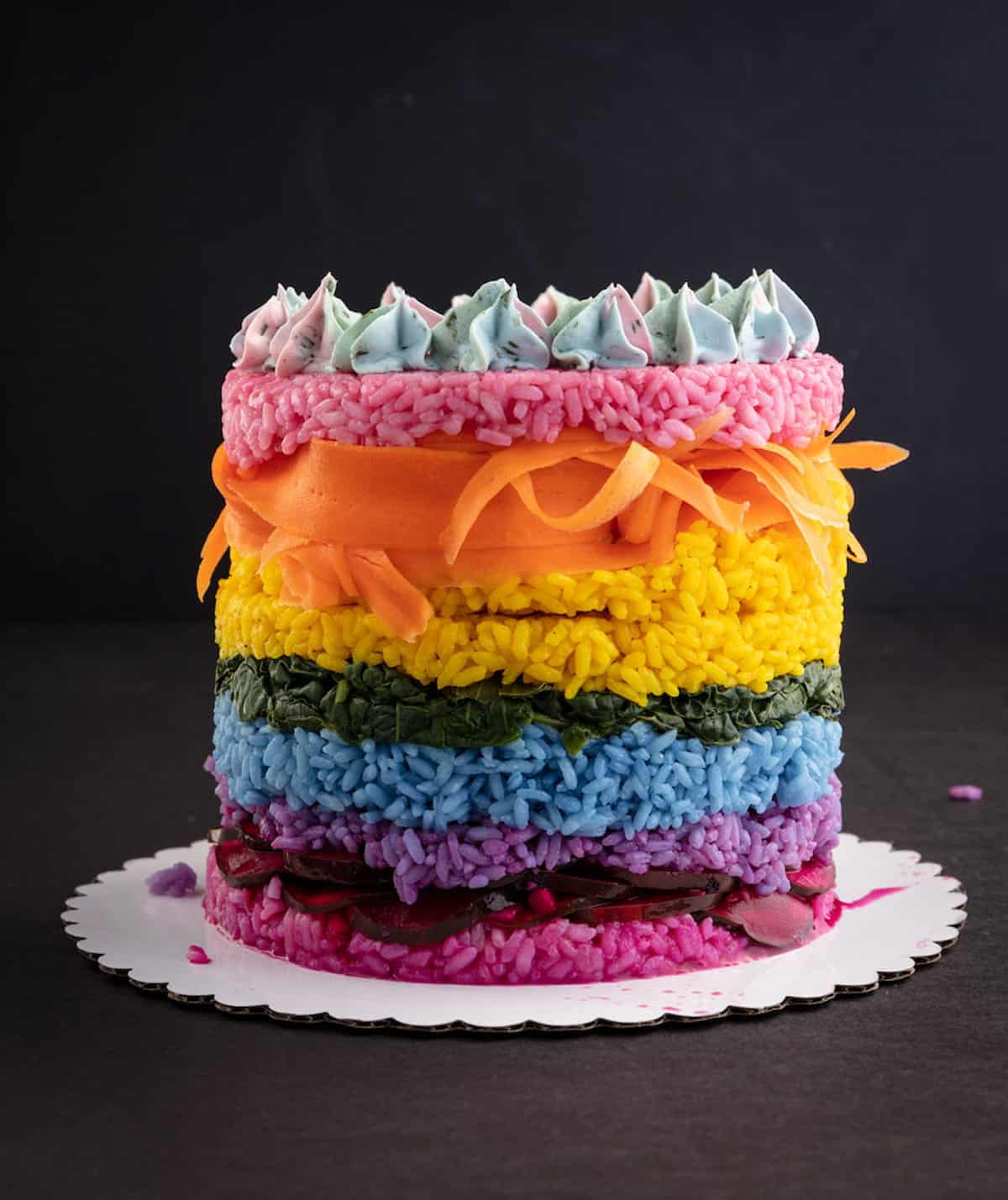 A rainbow sushi cake with colorful layers.