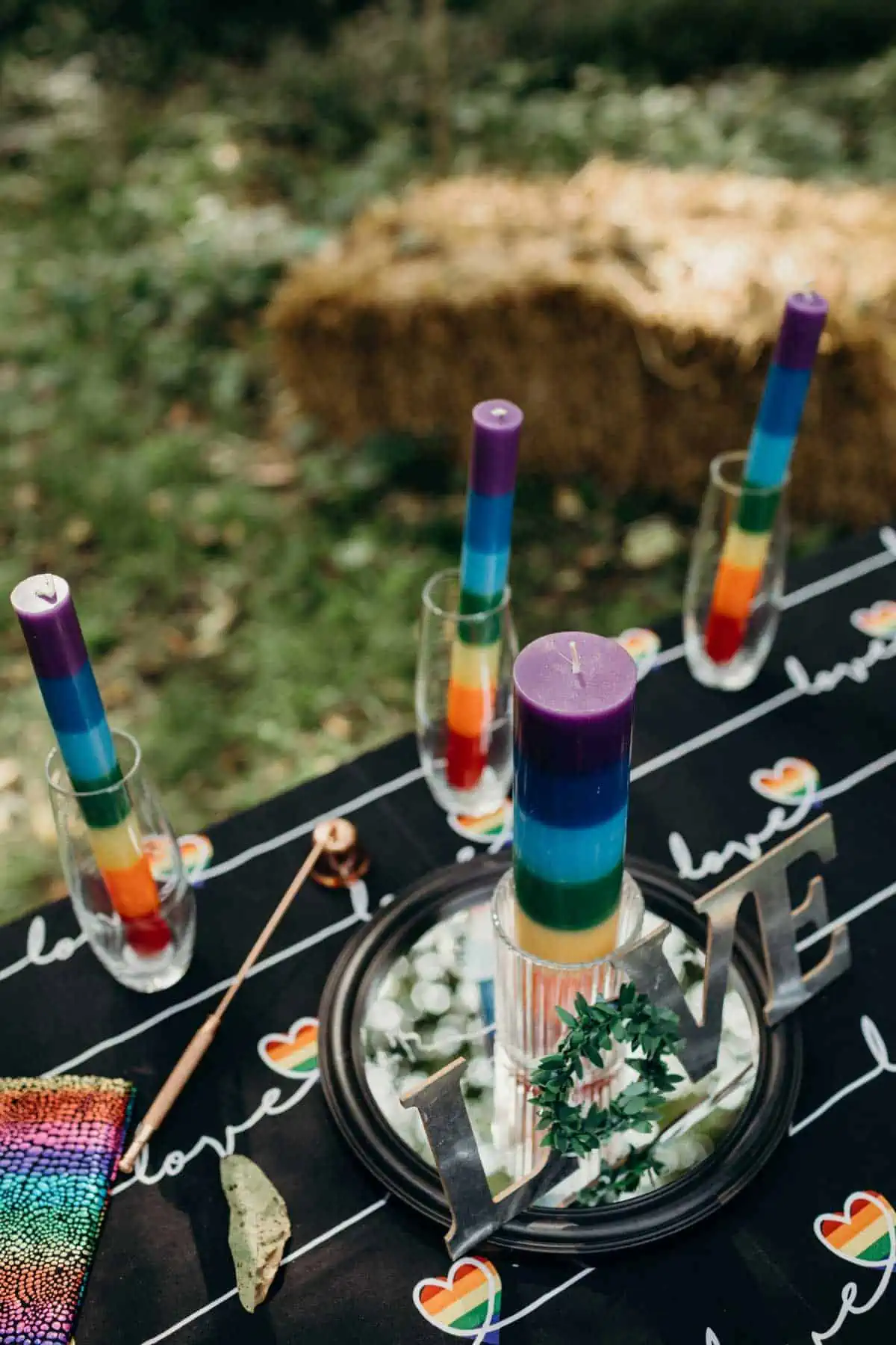 Rainbow dipped candles at a vegan wedding celebration. 