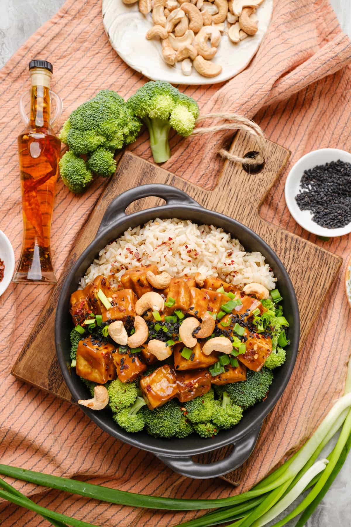 A bowl of Szechuan tofu served in a bowl with rice and broccoli.