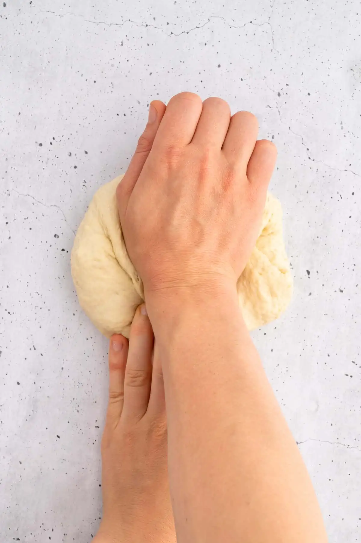 Pesto bread dough being kneaded.