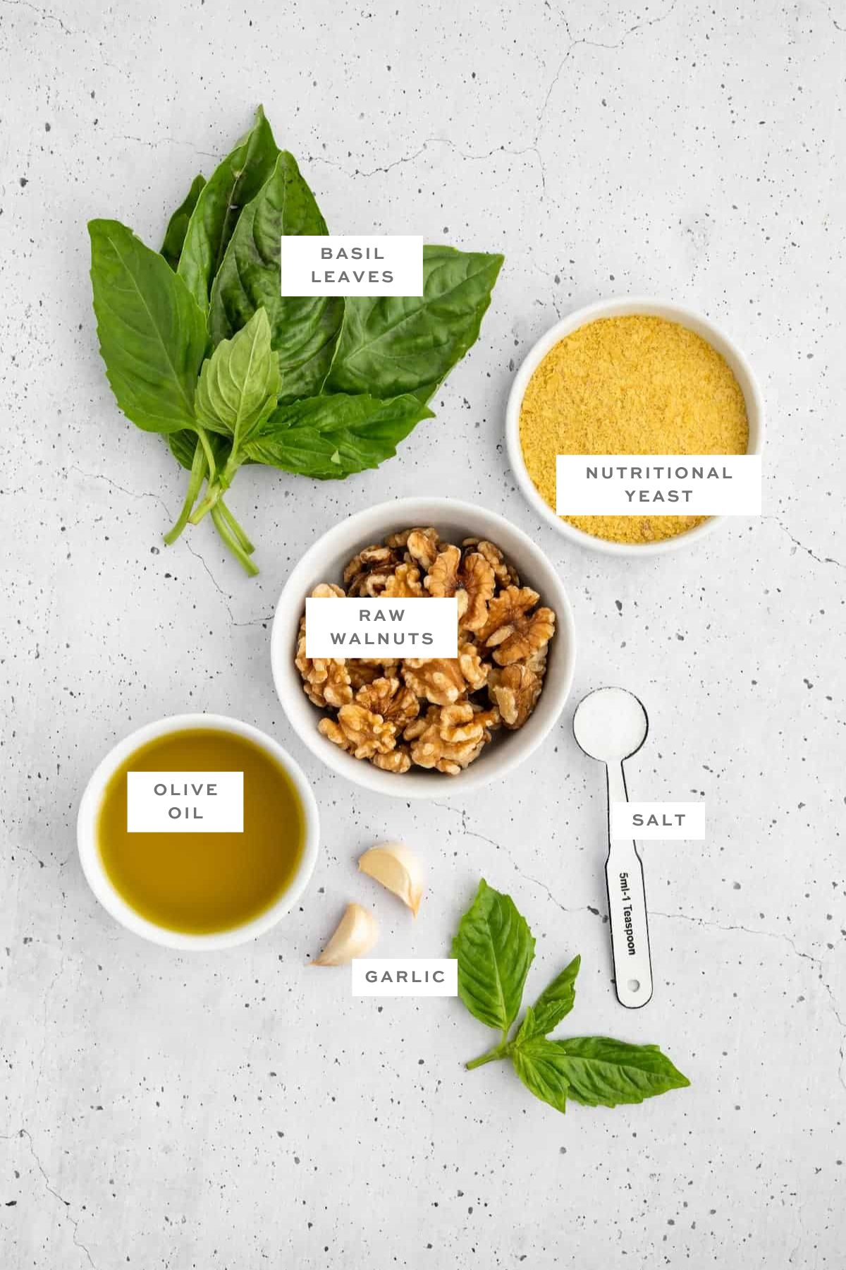 Ingredients for vegan pesto with labels.