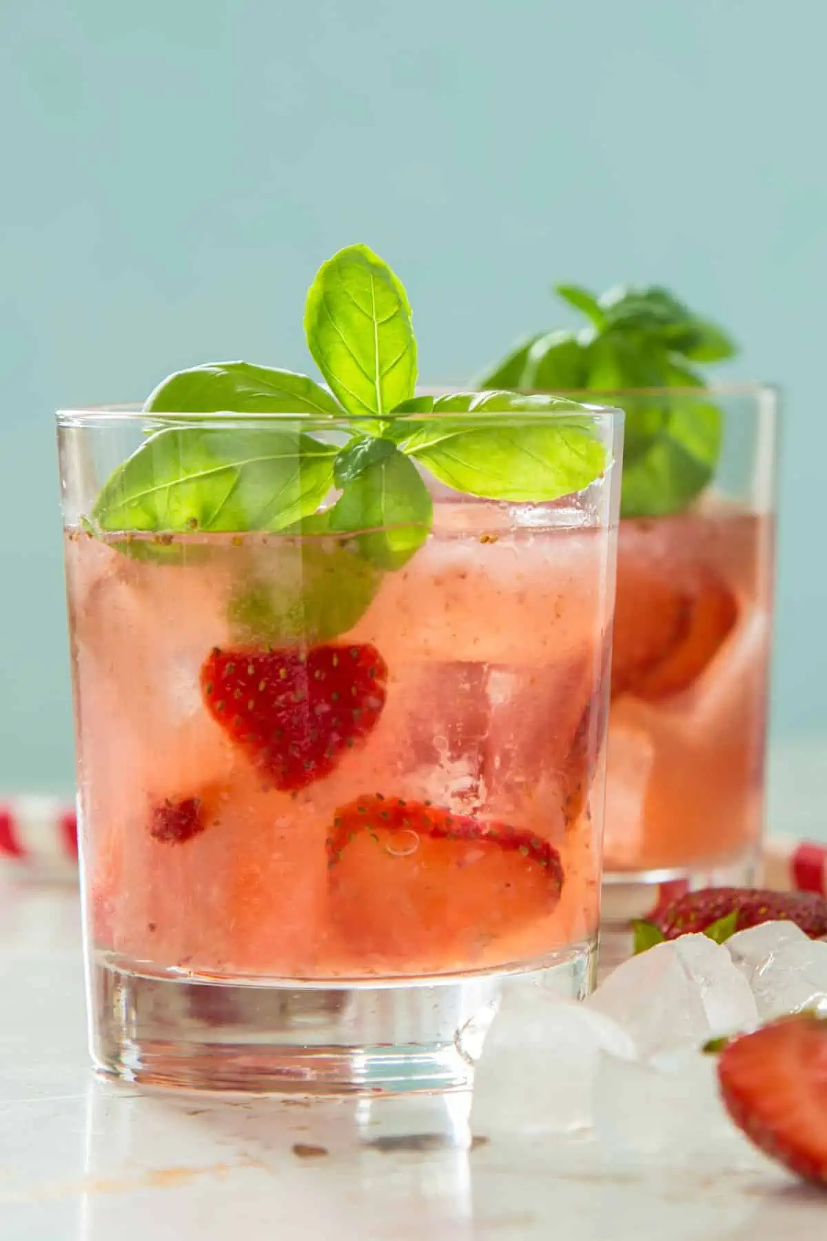 A glass of basil strawberry-infused water.