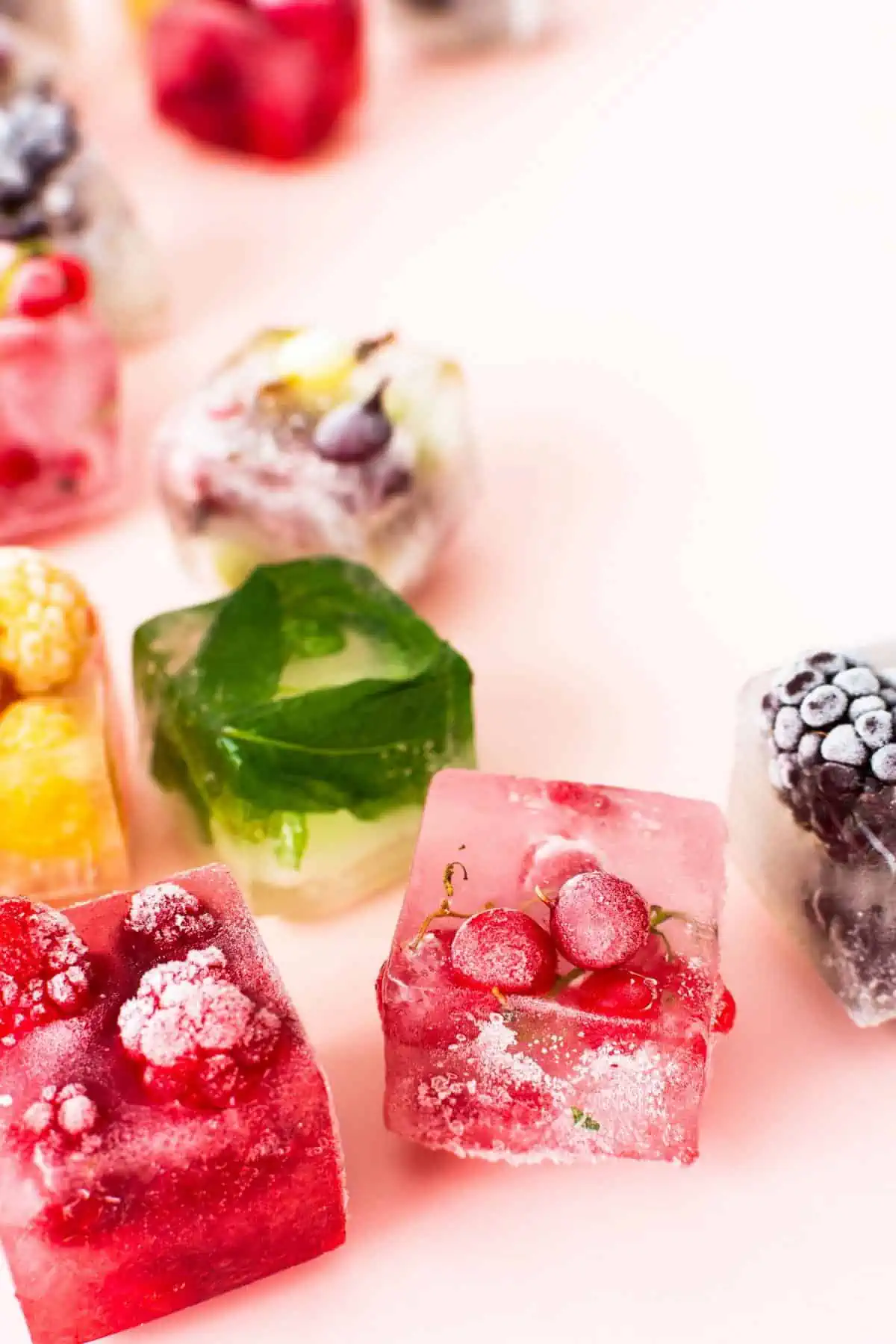 Ice cubes with basil and fruit frozen into them.