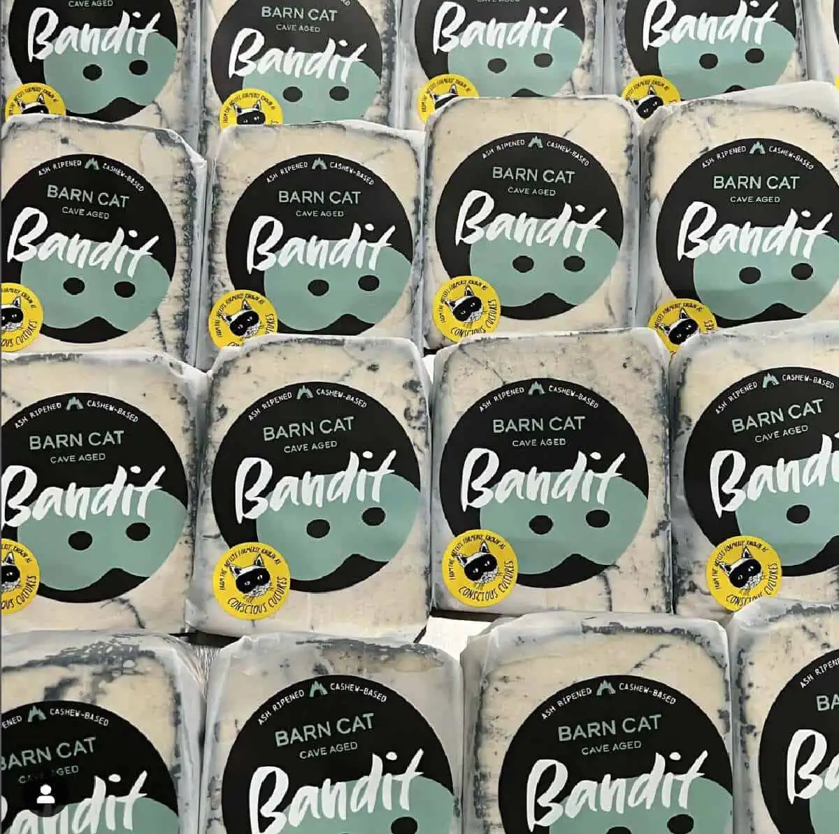 Sixteen square packages of Bandit Barn Cat Bleu Cheese in a checkerboard pattern with dark blue and pale green labels.