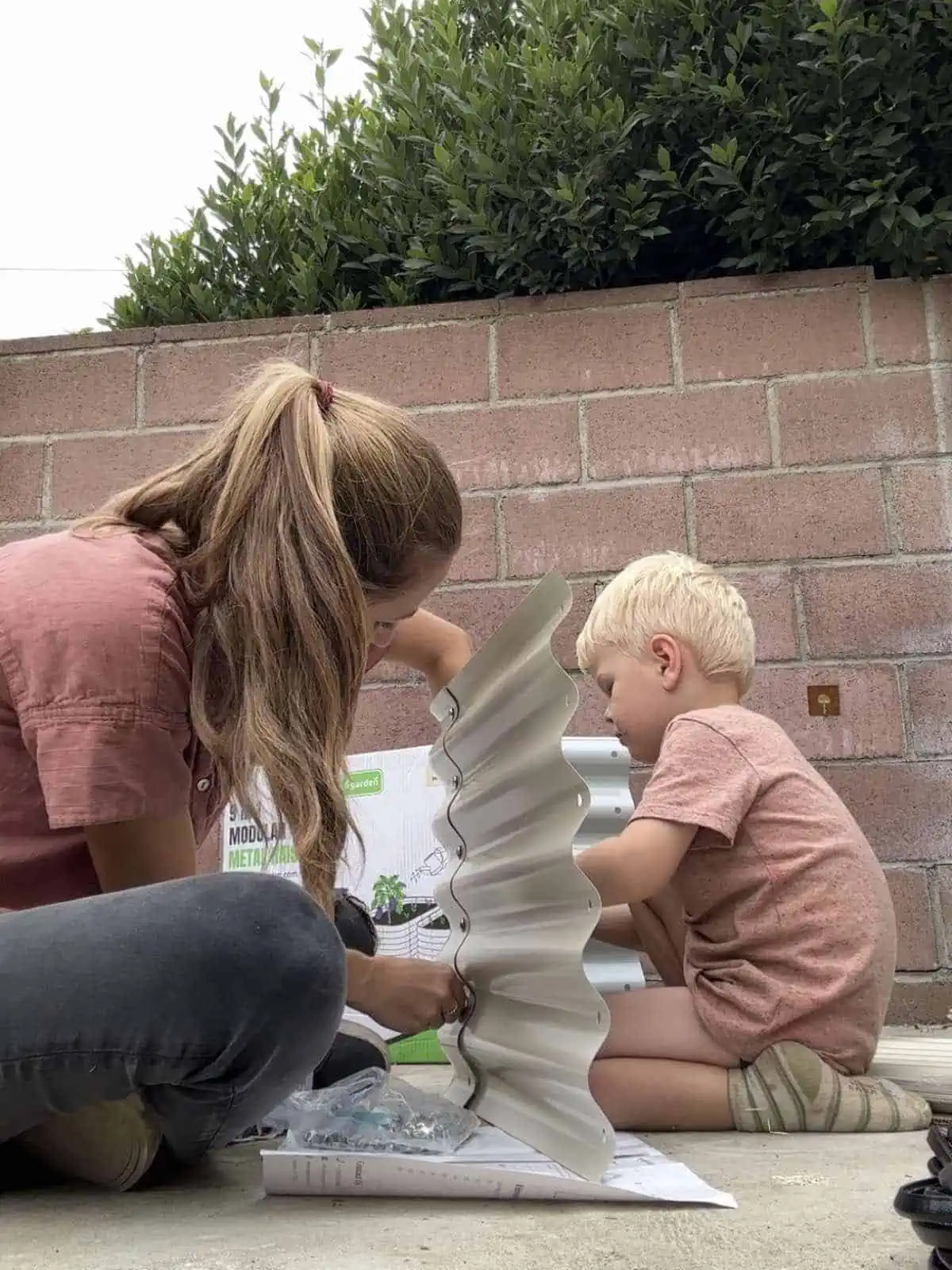 Mom and son building a garden bed.