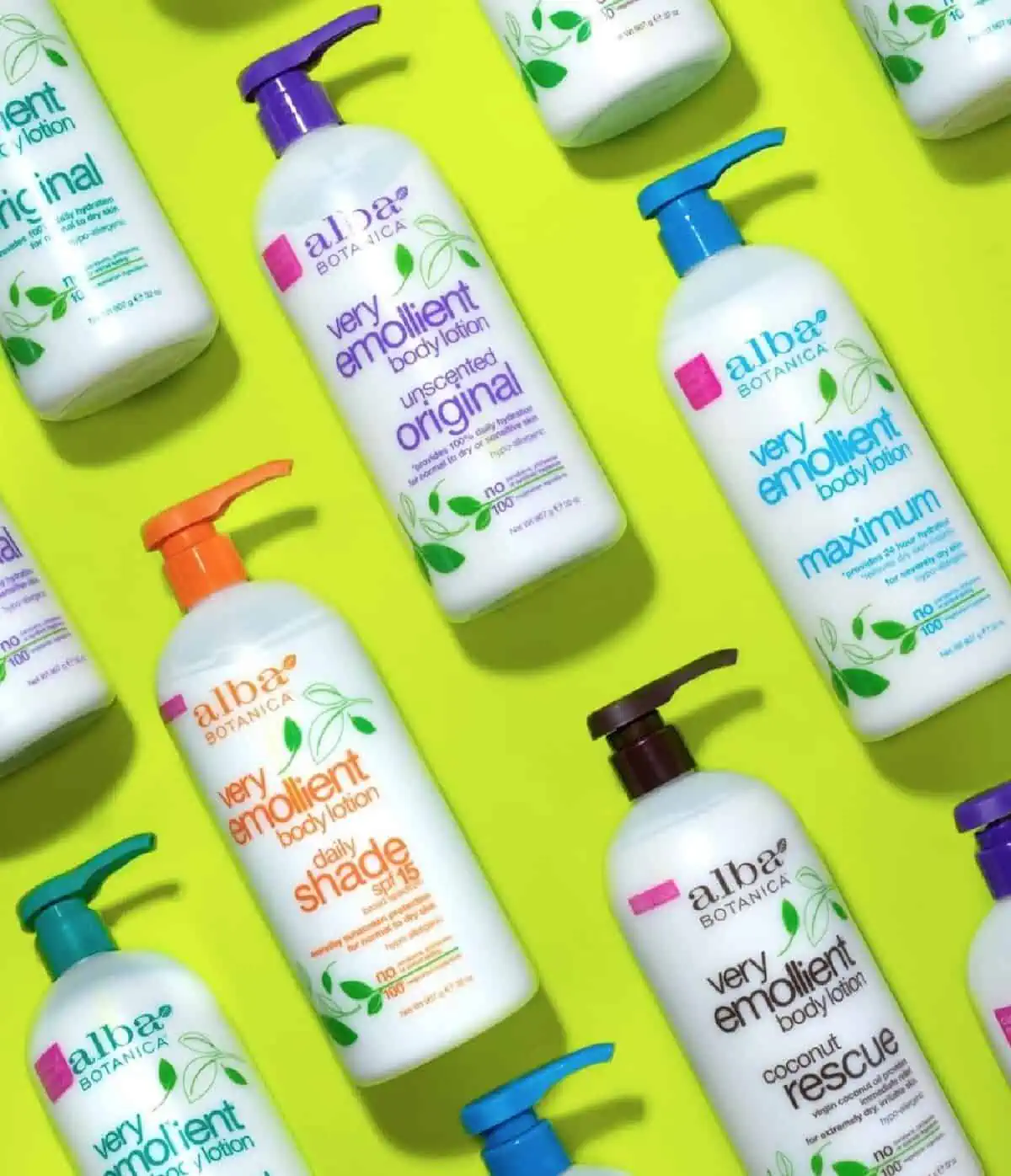 Several large bottles of Alba Botanica Very Emollient Body Lotion arranged in diagonal rows on a lime green background.